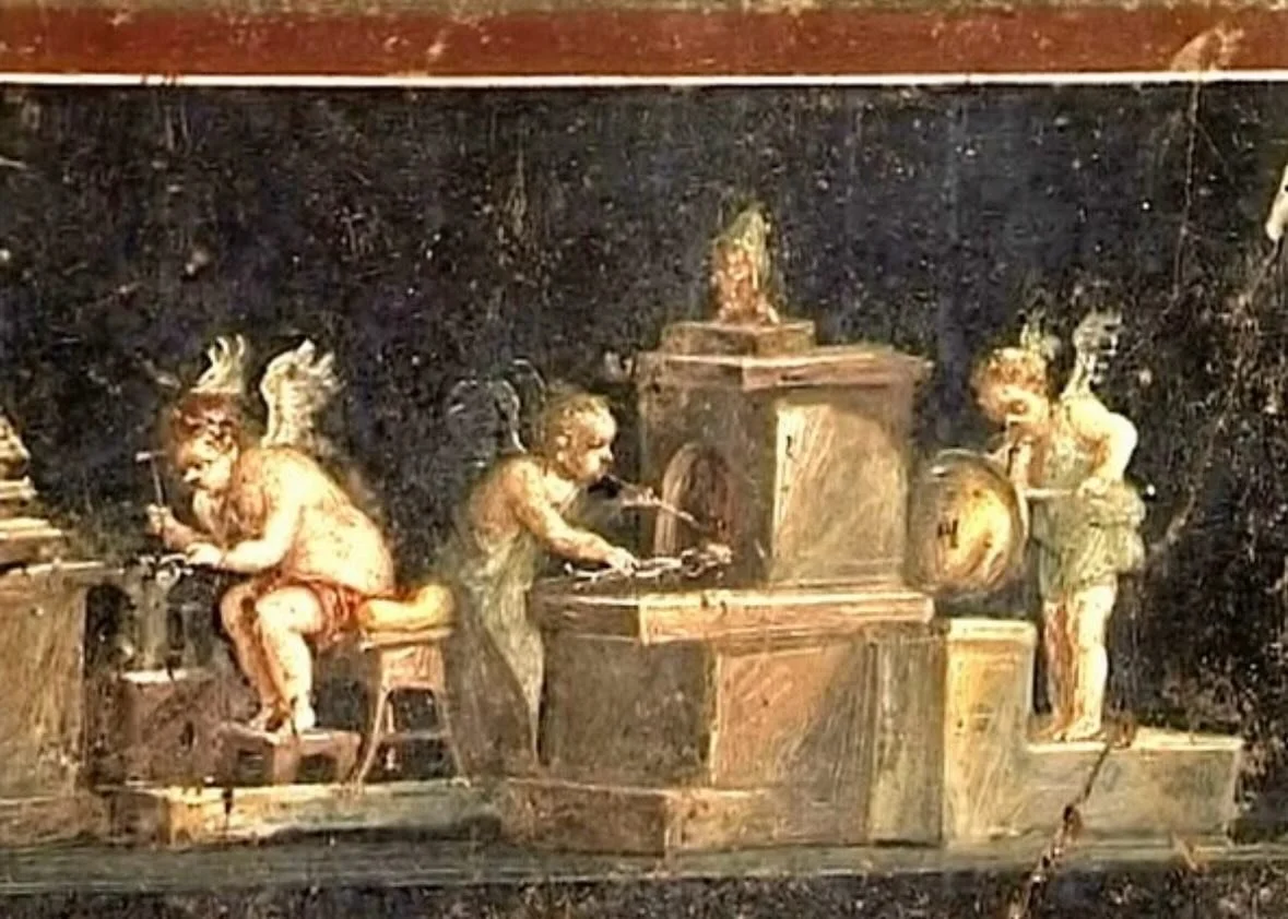 Cherub goldsmiths hammer it out until it shines so bright