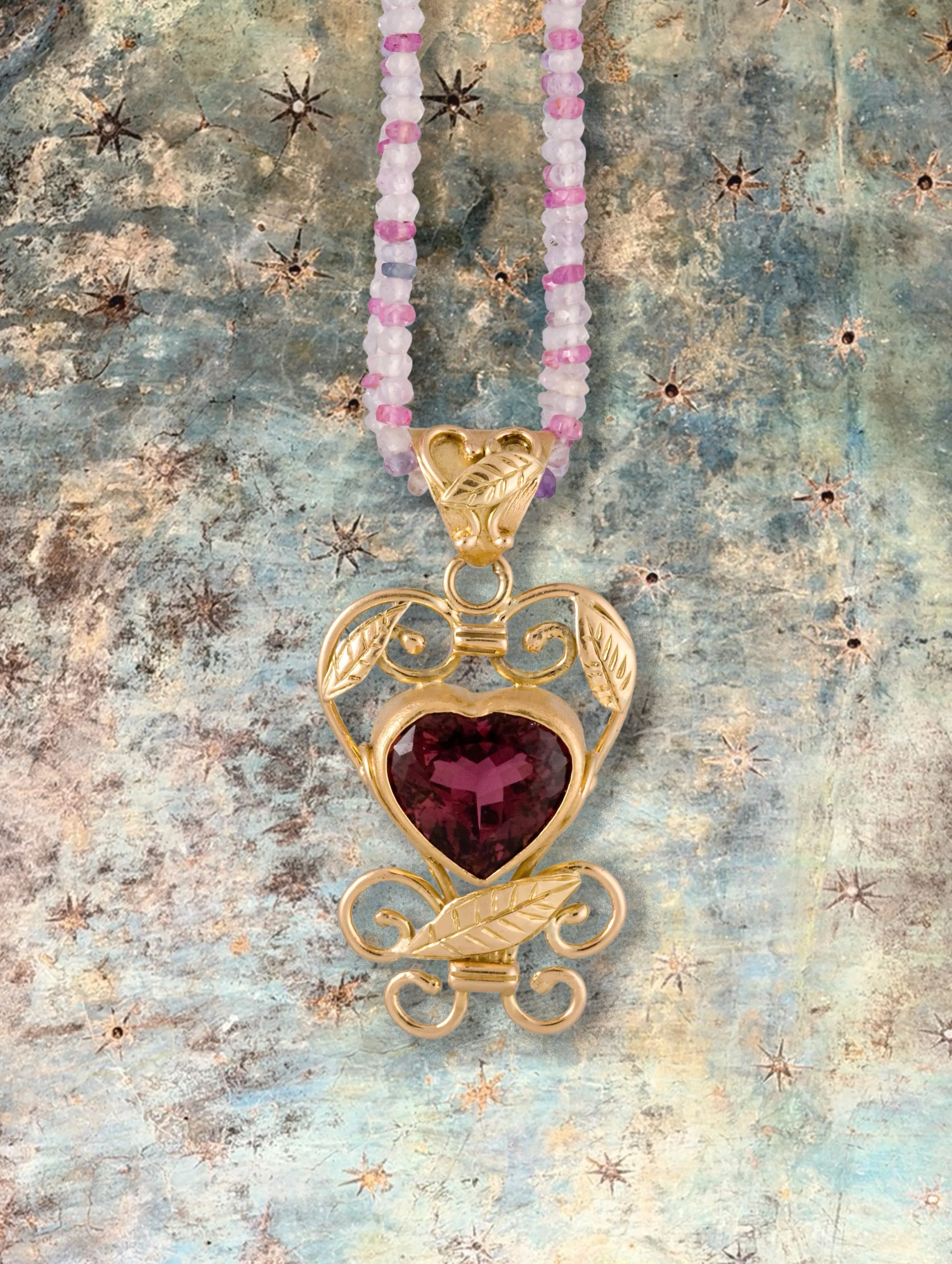 &ldquo;Iron to Gold&rdquo;

Pendant inspired by the gates of New York City. A one-of-a-kind piece fabricated from a custom alloy of 18-karat gold, rolled into sheets and wires before being sculpted into a heart-shaped setting with scrollwork. The hea