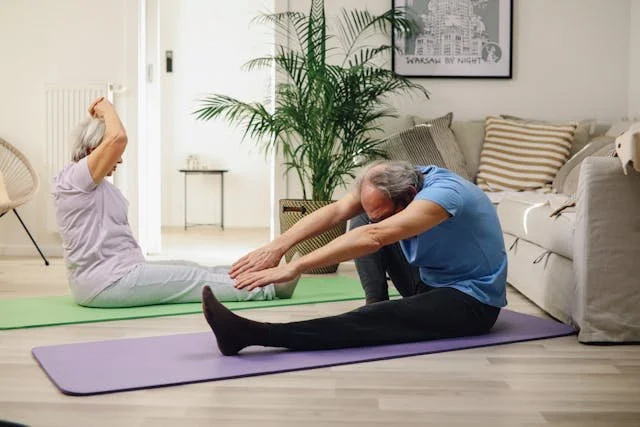 man and woman engage in gentle stretching