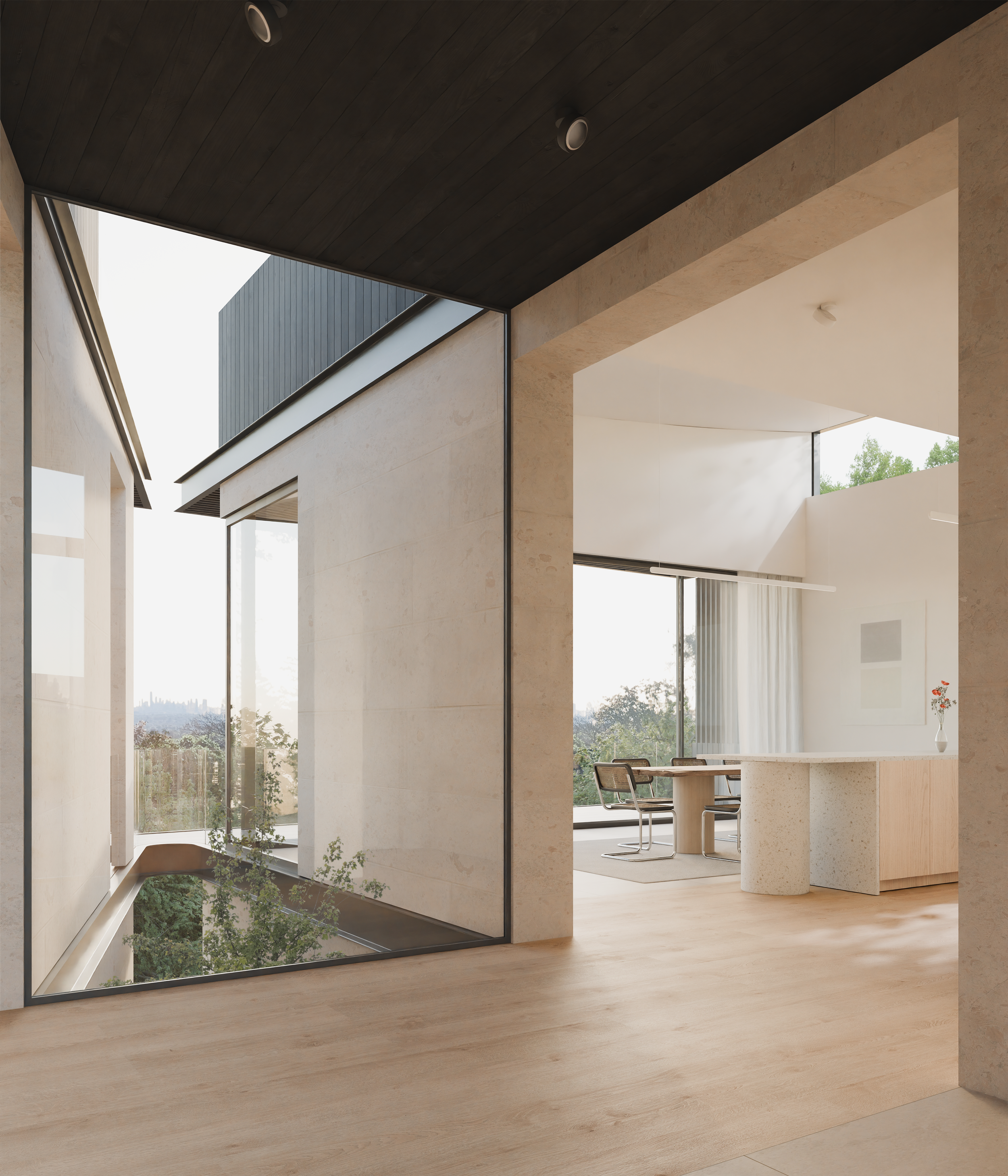 Modern interior view of a house with large glass windows, minimalist furniture, and natural light, showcasing a dining area with a round table and black chairs.