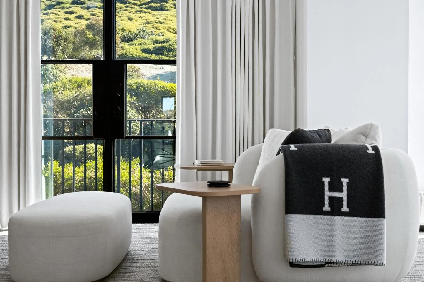 Primary bedroom suite featuring hotel-inspired custom seating and pleated draperies that beautifully frame the lush view. 🤍🖤

Photo Credit: @carealestatephotog 

#ashleyluxurydesign #luxury #azdesigner #ocdesigner #scottsdaleinteriordesign #interio