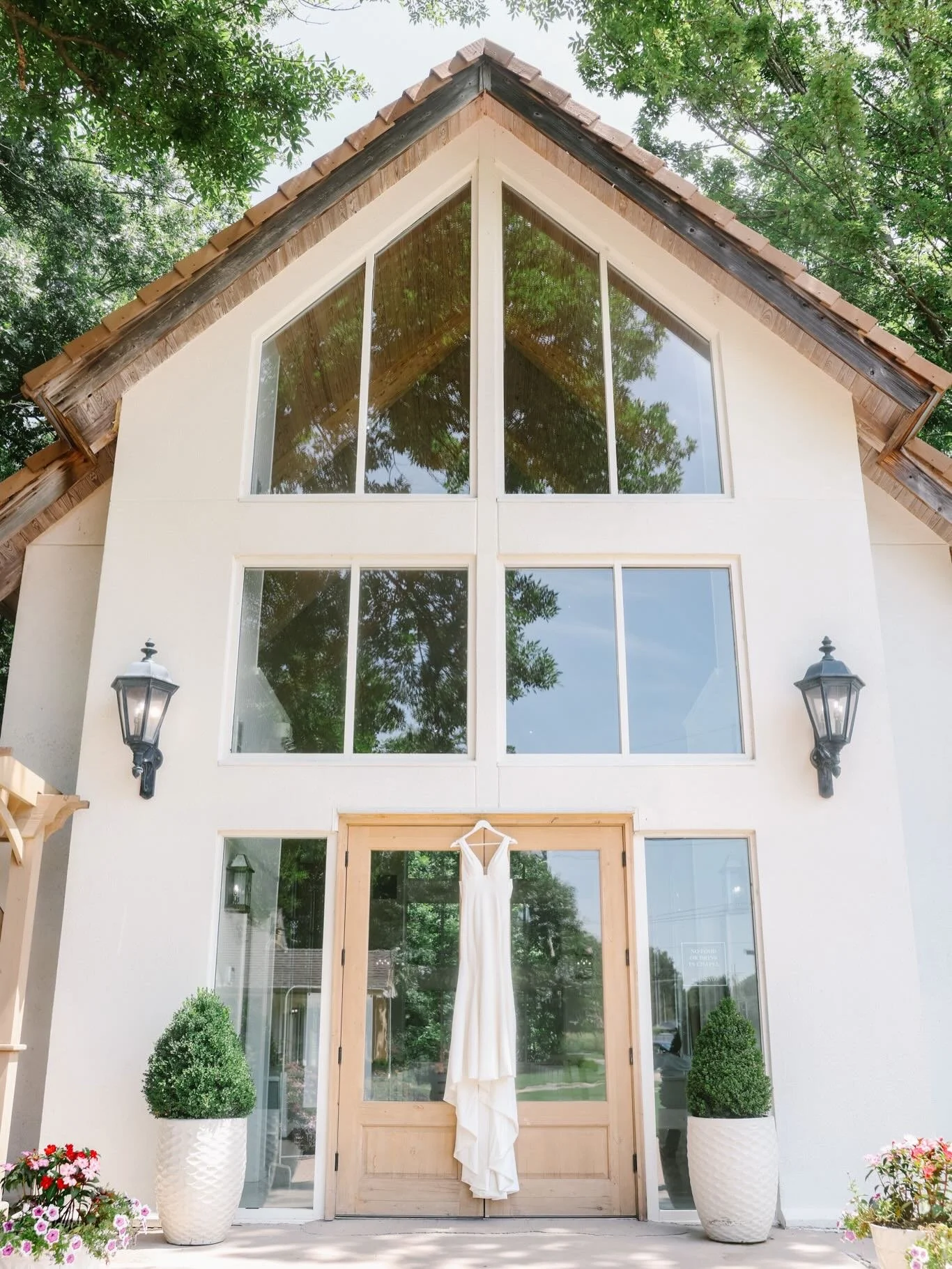 A stunning view of Kamryn&rsquo;s dress in front of the chapel😍

photo / @hannahvdrewphoto 
florist / @thefrenchbouquettulsa
linens / @partyprorents
cake / @ludgerscakes
dress / @molierebridal
suit / @menswearhouse
makeup + hair / @reillyteresitabea