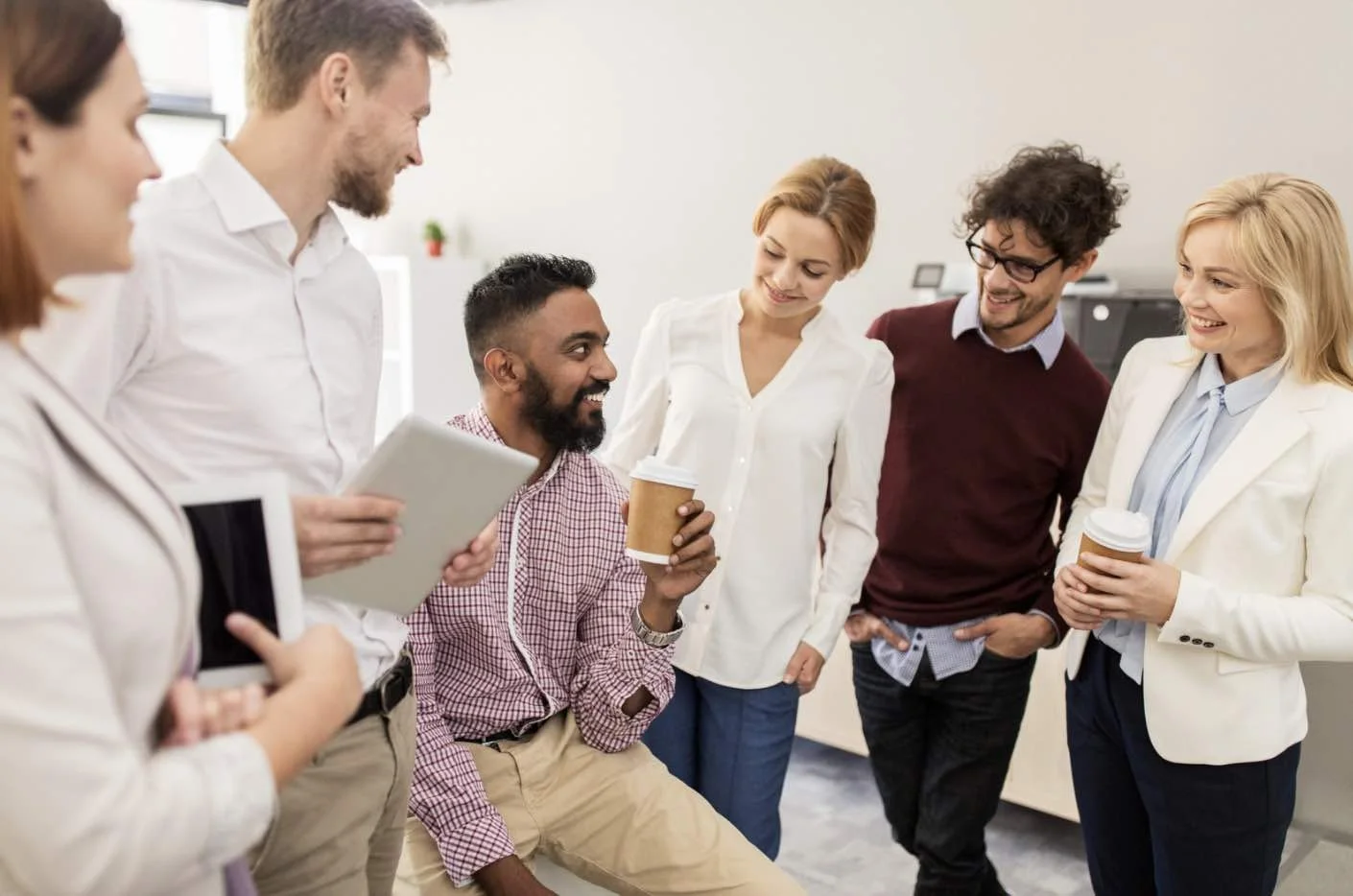 Group of coworkers smiling together after playing get to know you bingo