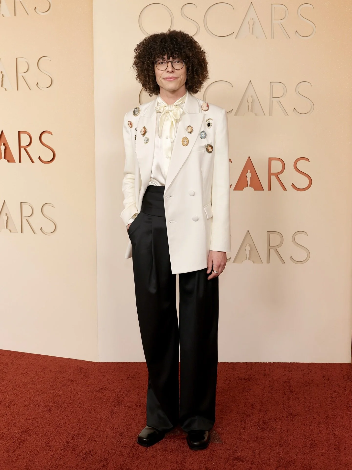 @guywithamoviecamera in custom TF at the Oscars 🤍 

A satin faced wool double breasted blazer adorned with vintage and antique cameo brooches sourced by T&amp;F

Paired with a satin faced wool pleated trouser and silk charmeuse bow tie blouse 

Styl