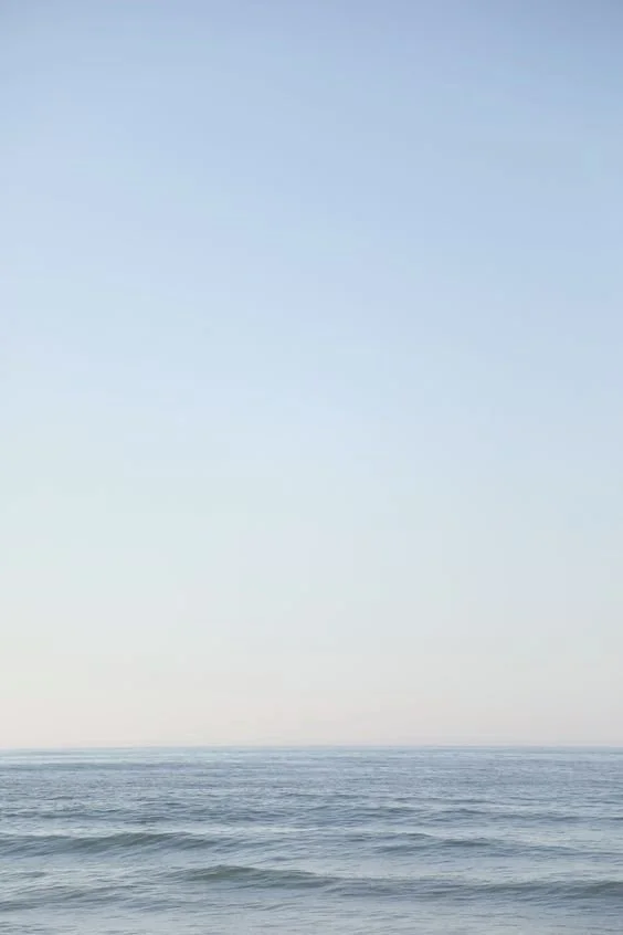 Calm ocean with gentle waves under a clear sky