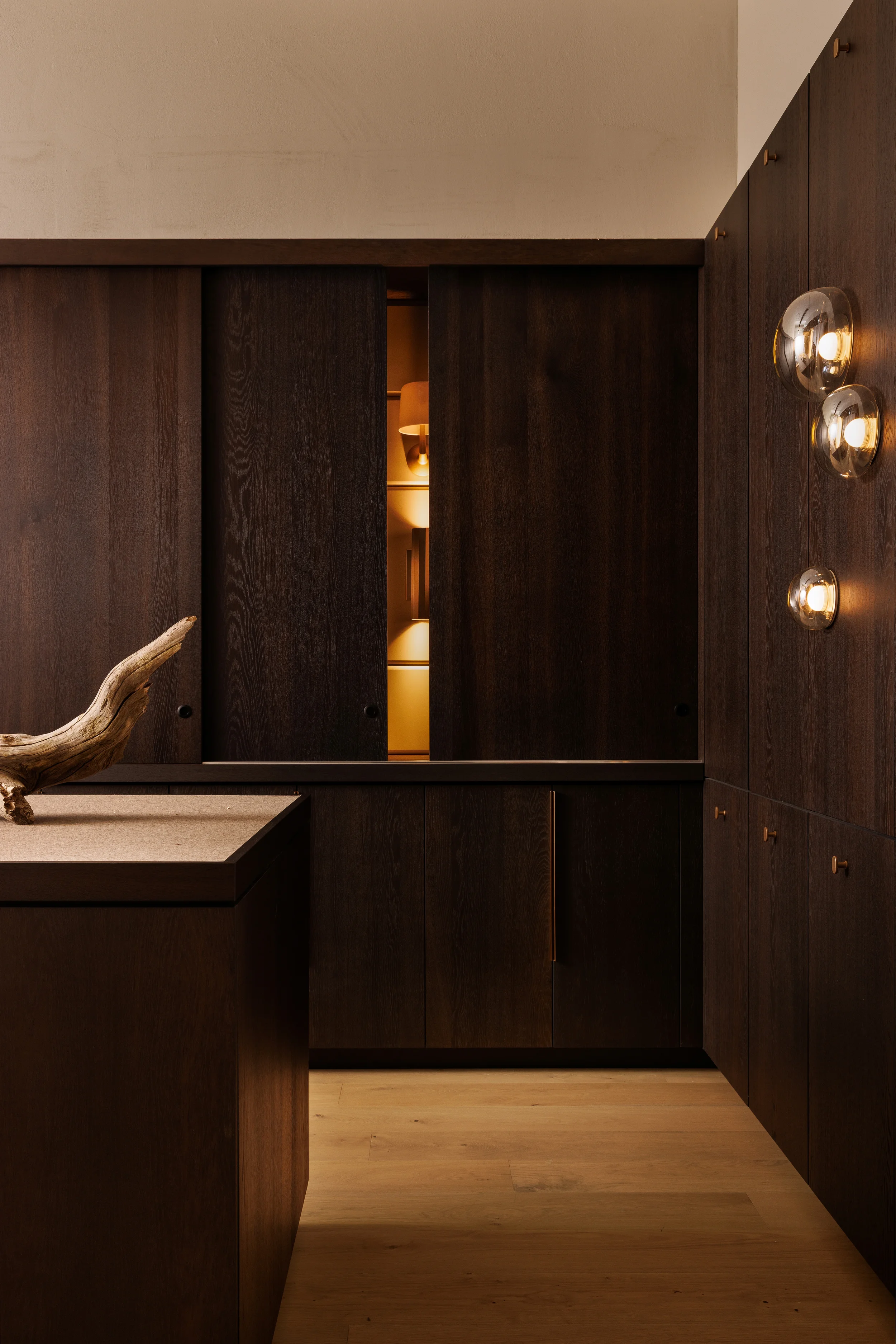 LightForm showroom featuring dark walnut millwork and decorative wall lighting in Vancouver BC by Little Giant