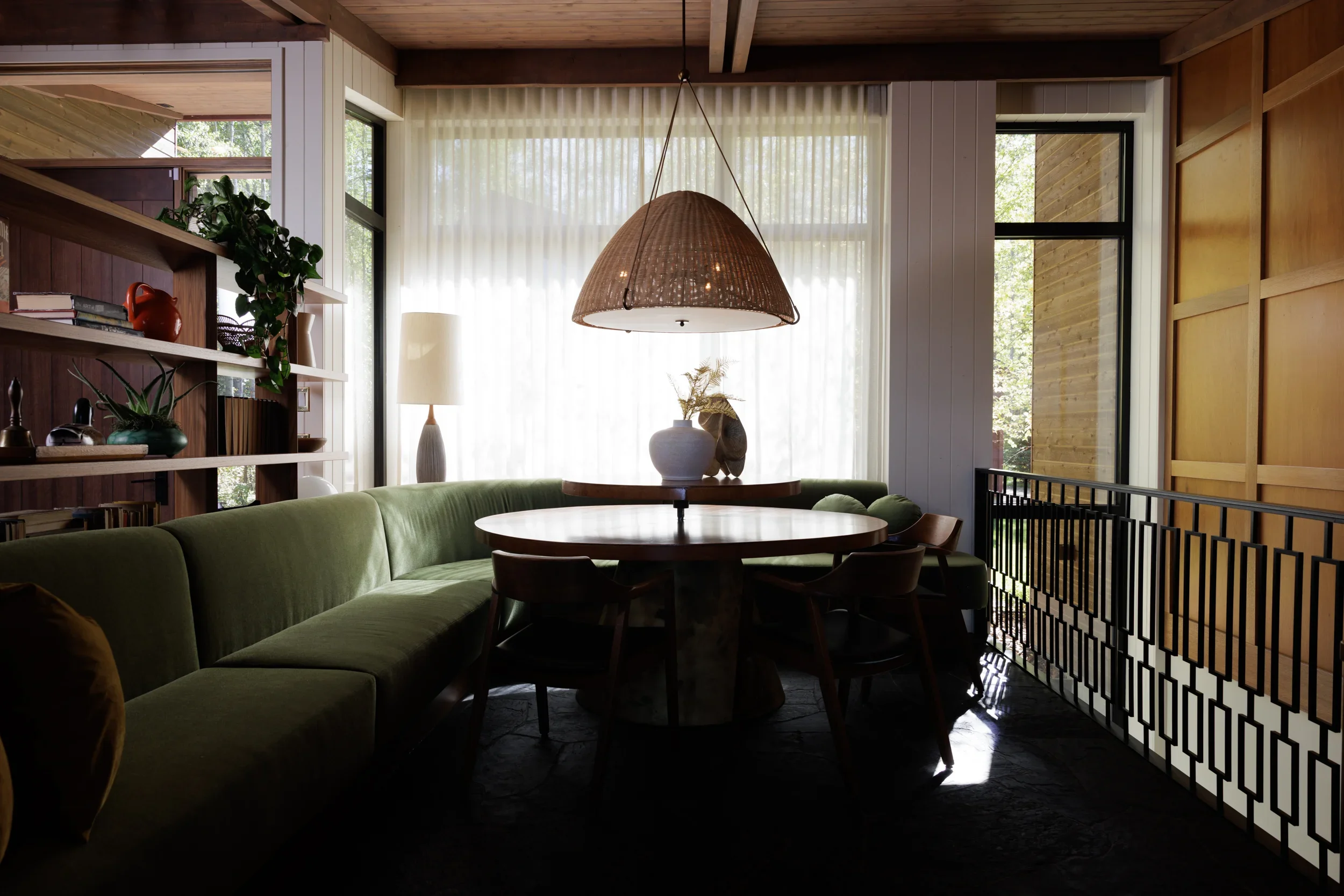 Warm residential interior with natural wood finishes and expansive lake views in Sylvan Lake, Alberta by Little Giant