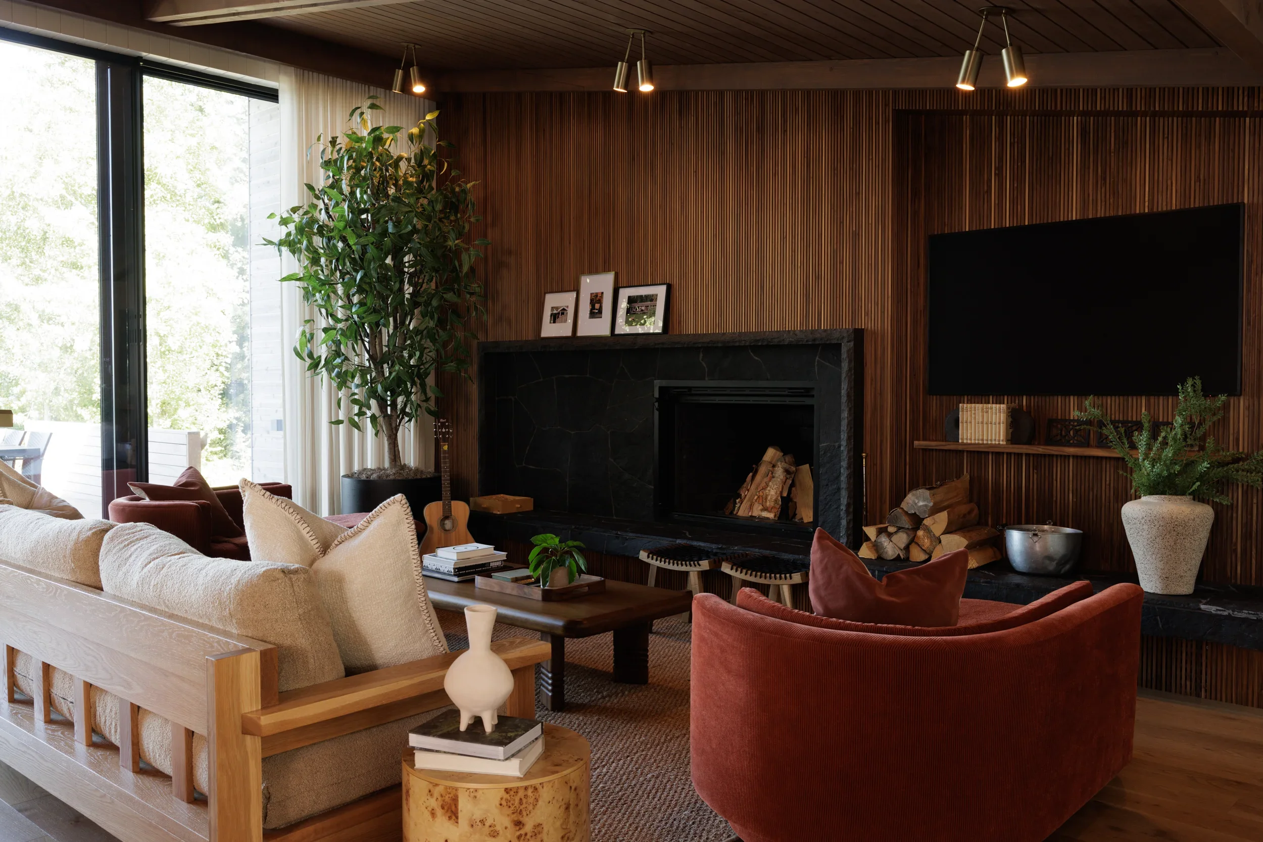 Warm residential interior with natural wood finishes and expansive lake views in Sylvan Lake, Alberta by Little Giant