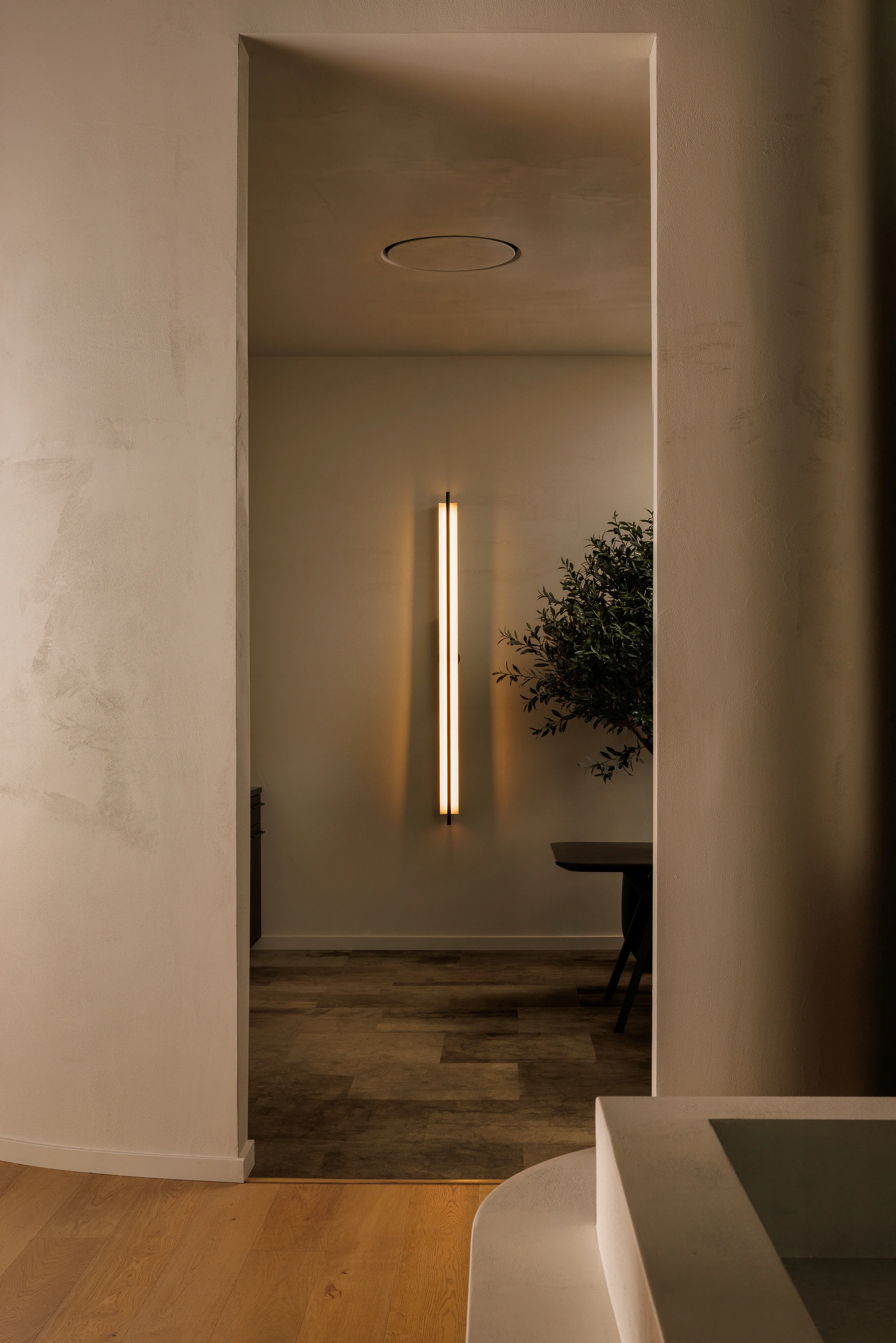 LightForm showroom featuring integrated vertical wall lighting and minimalist architectural interiors in Vancouver BC by Little Giant