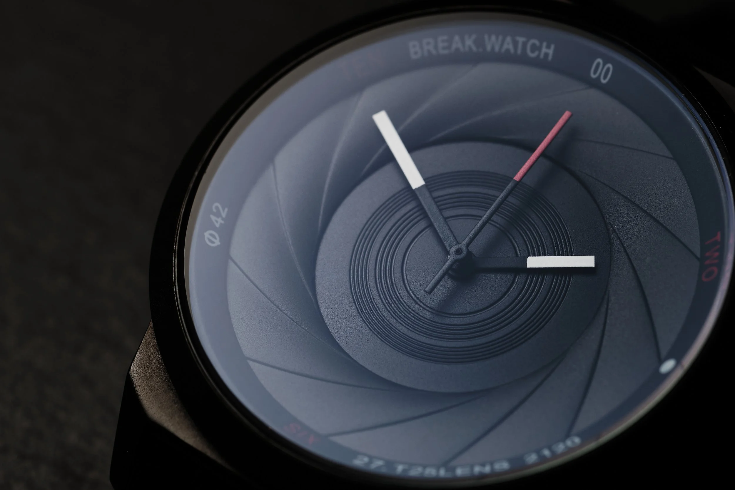 Close-up of a smartwatch face showing the time with hour, minute, and second hands, and various markings around the edge.