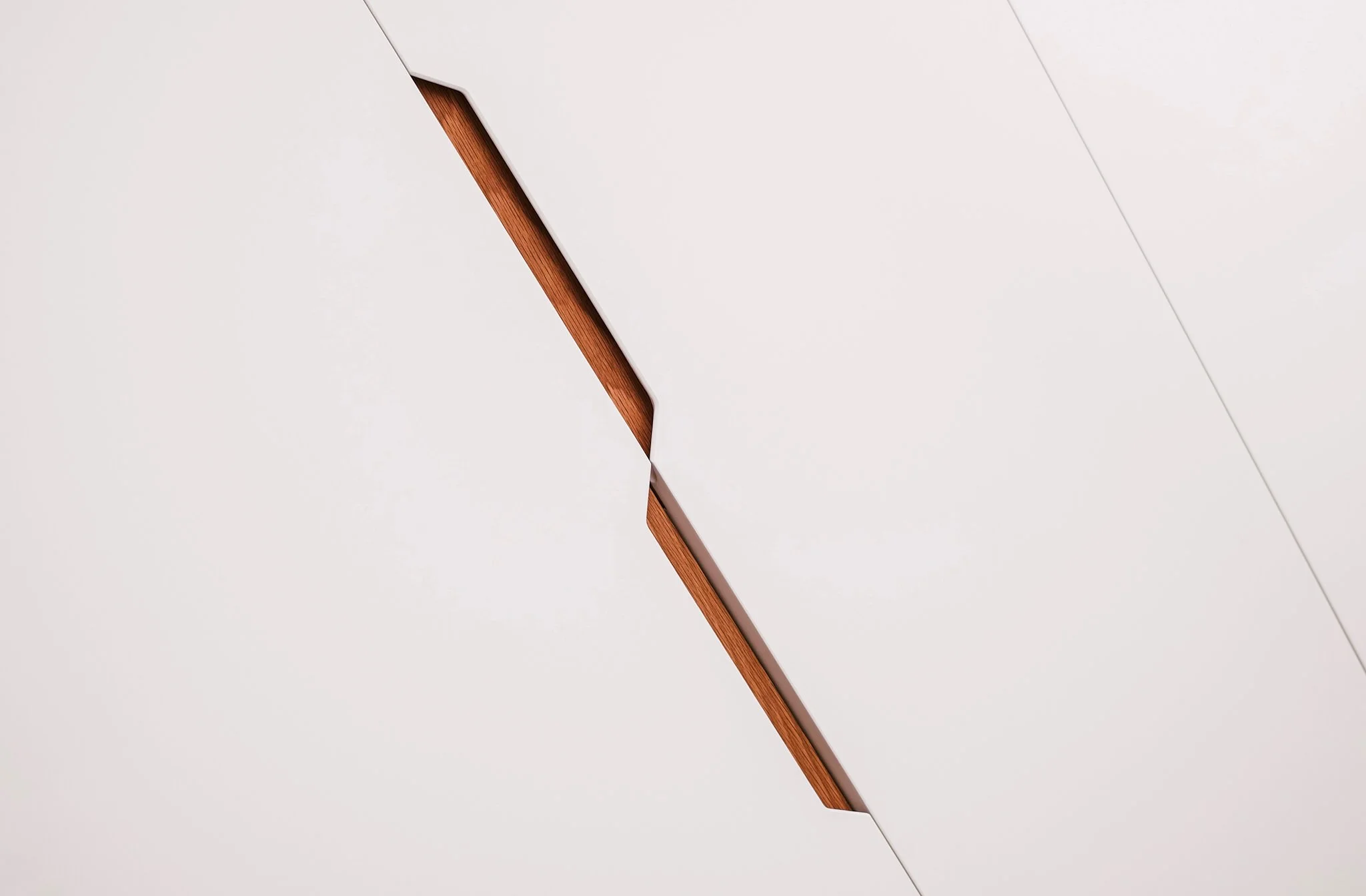 Close-up of a white ceiling with a recessed section revealing a wooden surface inside.