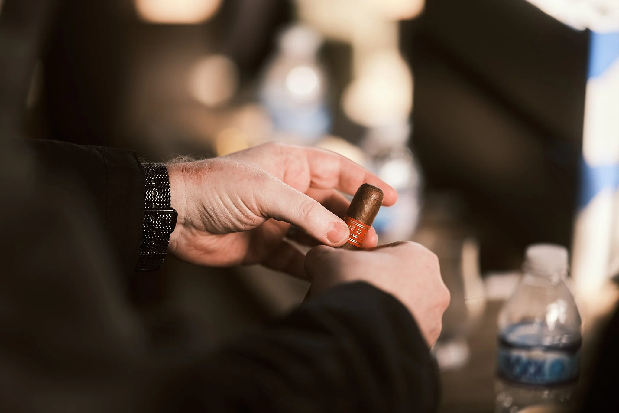 A person is holding a cigar.