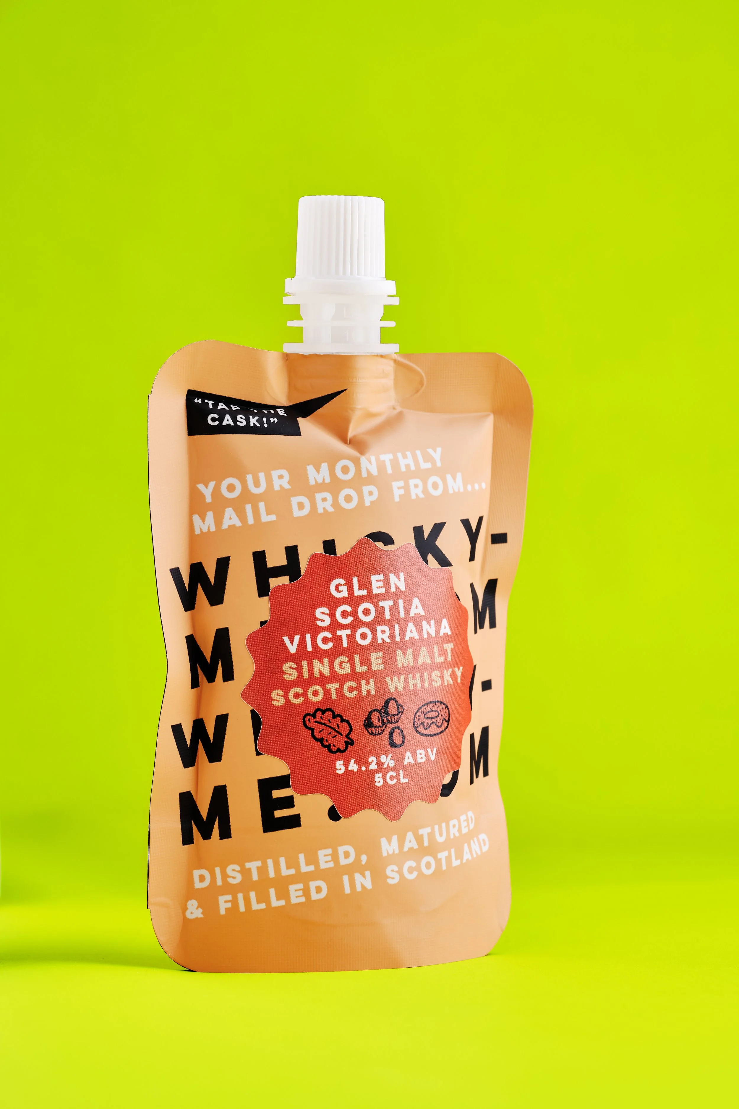 A pouch of single malt Scotch whisky against a bright green background.