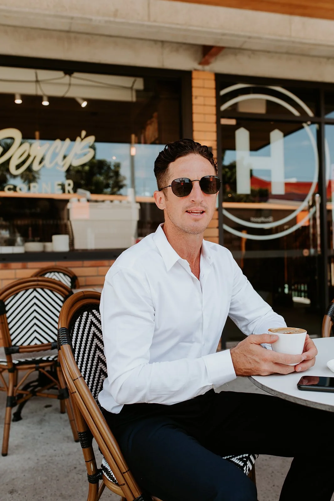Gold Coast personal branding photographer captures male professional seated in cafe during Gold Coast personal branding photography session.
