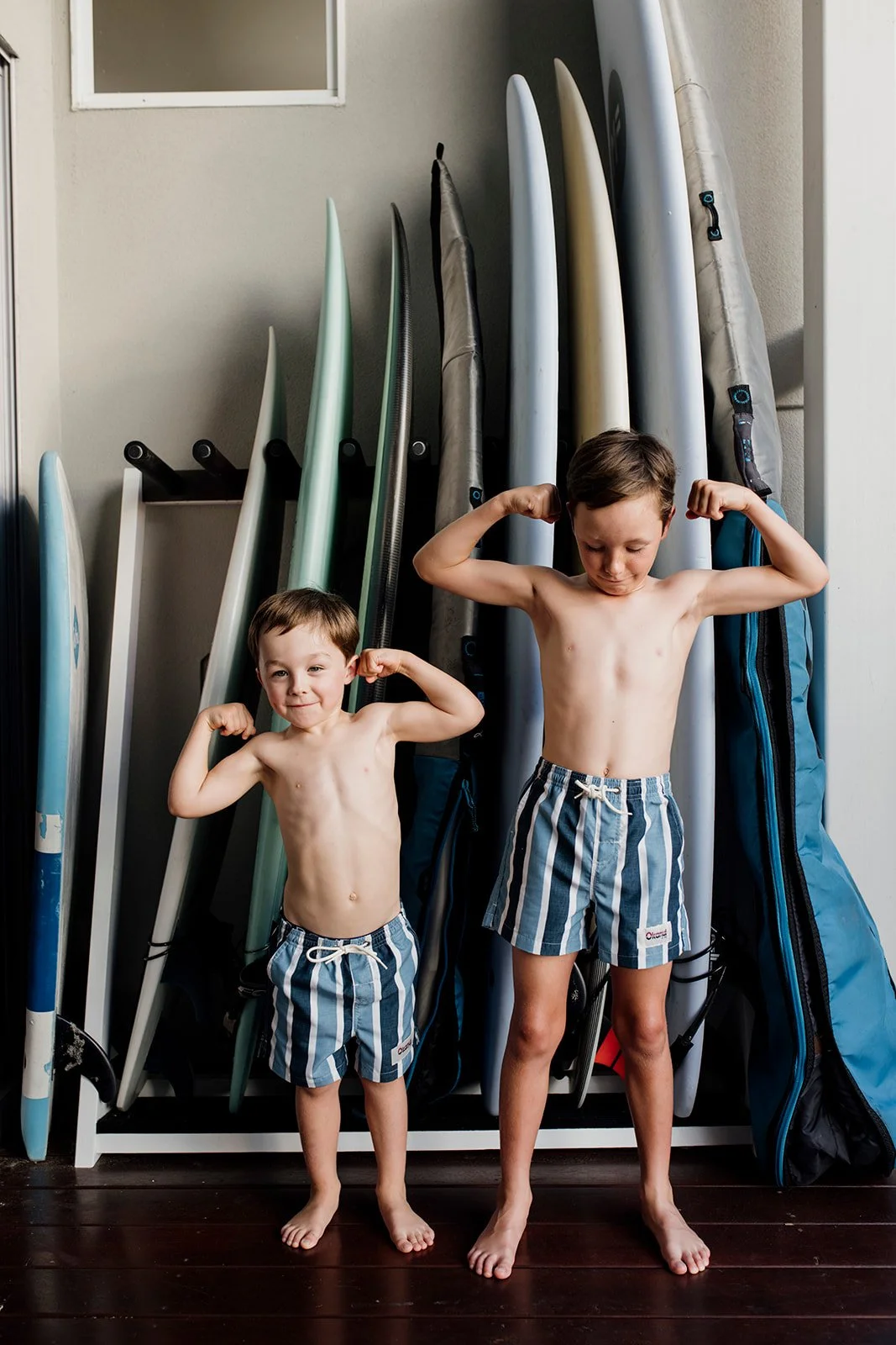Gold Coast photographer captures brothers at home with surf boards during Gold Coast photo shoot.