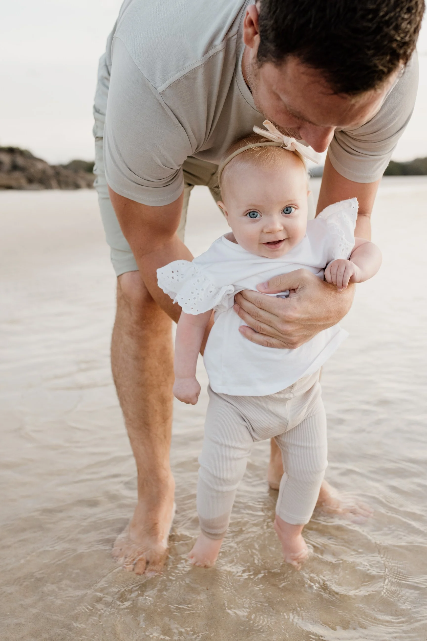 Gold Coast photographer captures young girl and father at the beach during Gold Coast family photography session