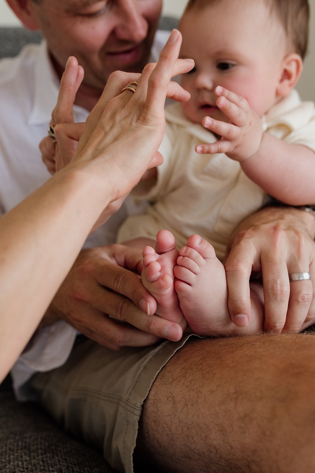 Gold Coast newborn photographer captures parents at home with baby during Gold Coast newborn photo shoot.