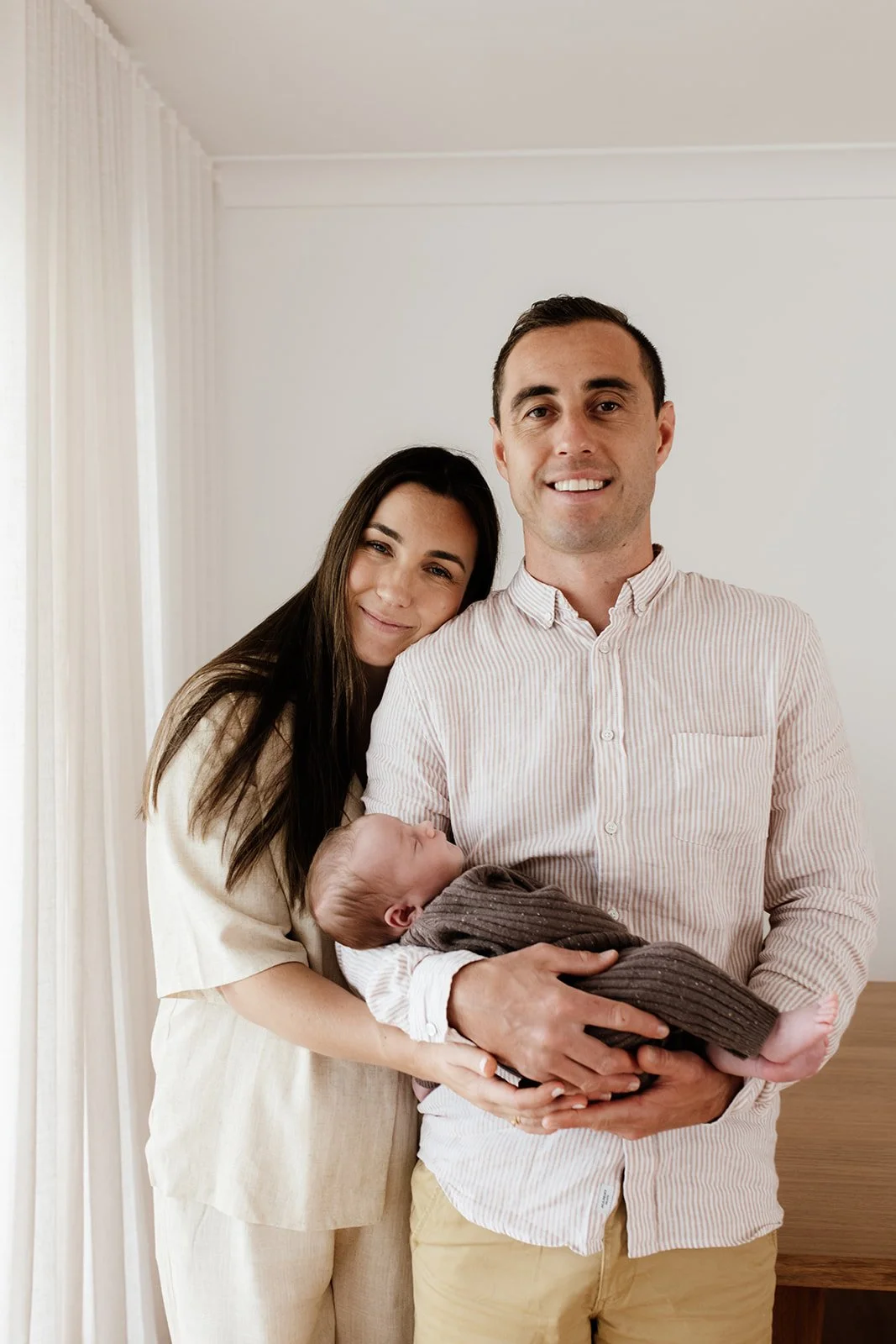 Tweed Coast newborn photo shoot captures parents and baby at home during Tweed Coast baby photo shoot.