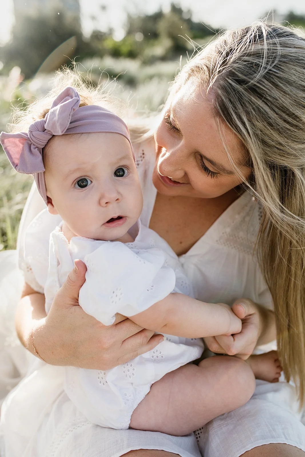 Young mum and daughter together during Gold Coast family photographer shoot at the beach.