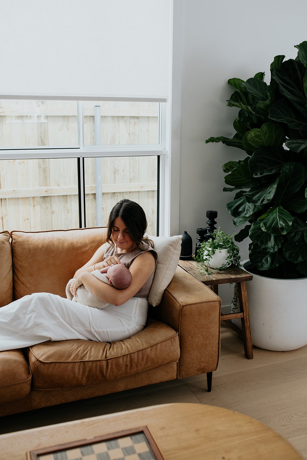 Northern Rivers newborn photography session at home with mother and baby on the couch.