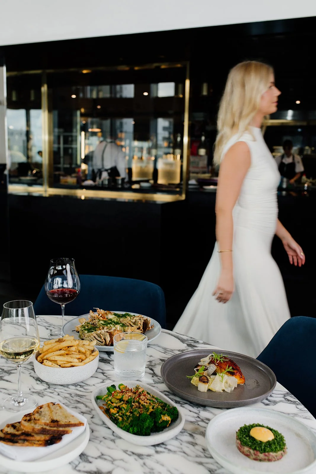 Gold Coast restaurant photographer captures lady walking through restaurant during Gold Coast restaurant photography session.