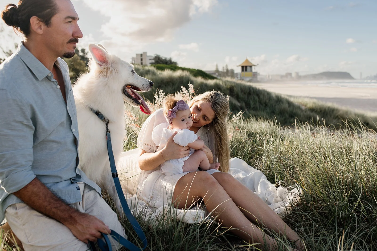 Gold Coast photographer captures young family at the beach in the sunshine with their dog during Gold Coast family photo shoot.
