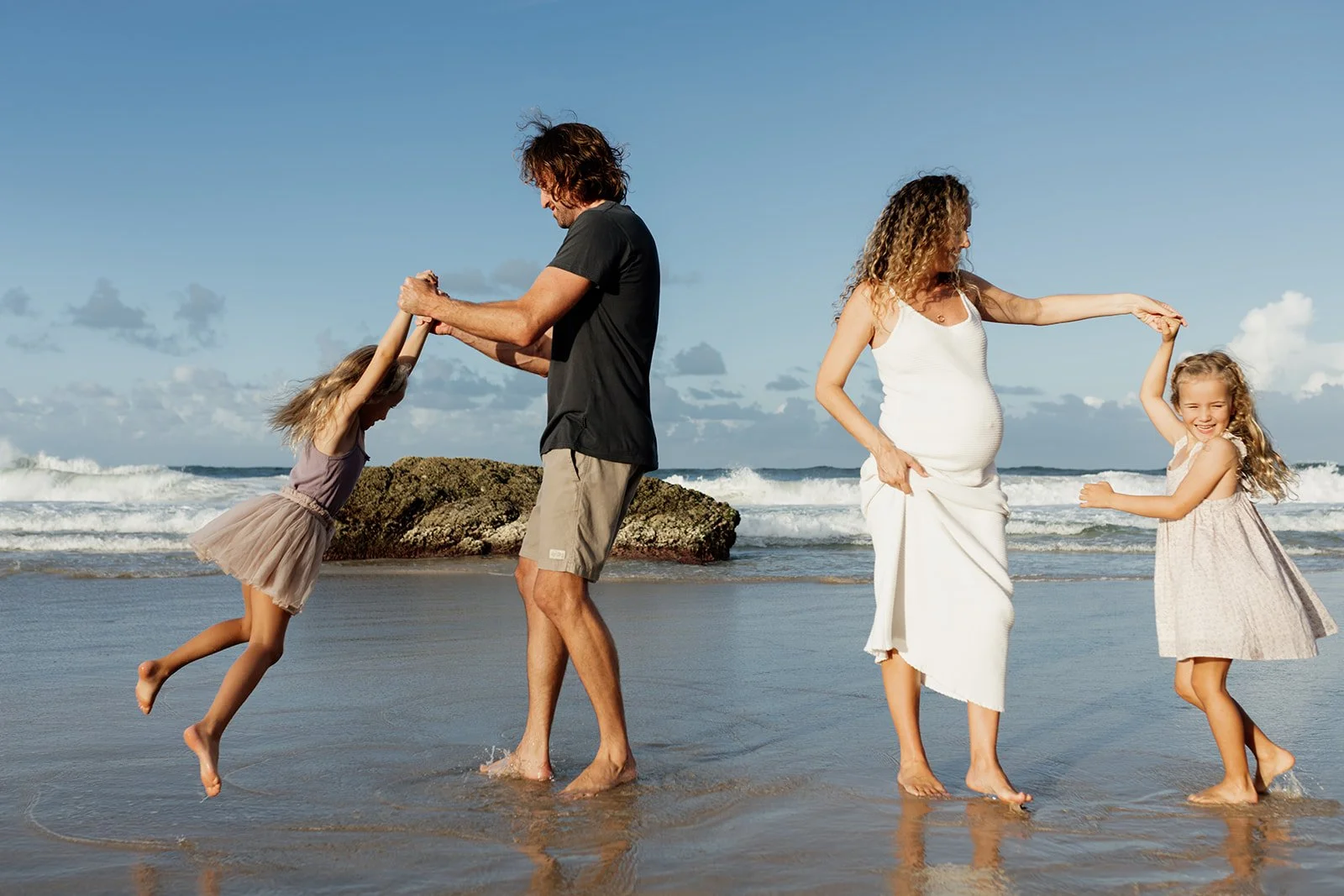 Gold Coast maternity photographer captures young family together at the beach during Gold Coast maternity photo shoot.