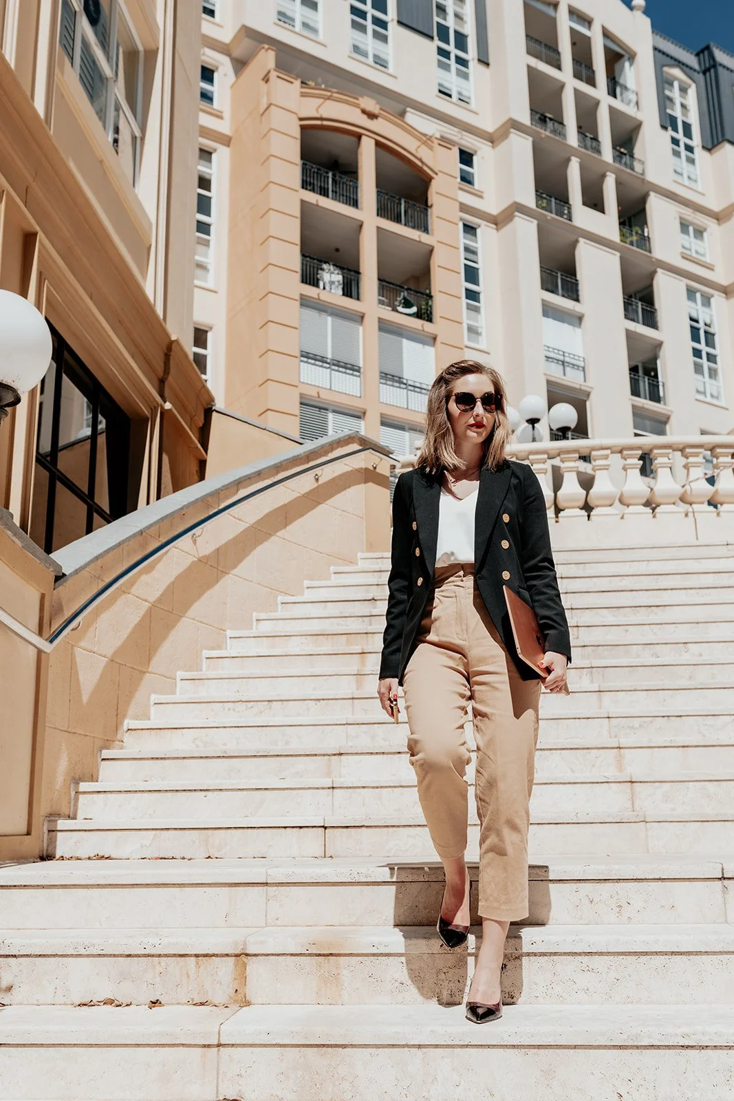 Brand photographer Gold Coast captures solo female business owner on stairs during Gold Coast branding photo shoot.