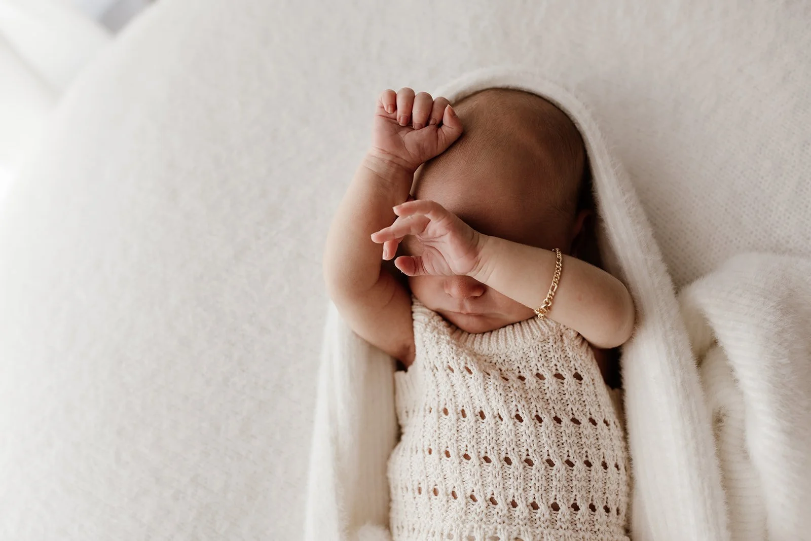 Byron Bay family photographer captures new baby at home on beanbag during baby photography shoot.