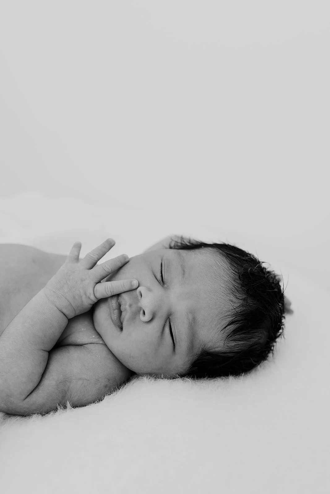 Byron Bay family photographer captures new baby at home on beanbag during baby photography shoot.