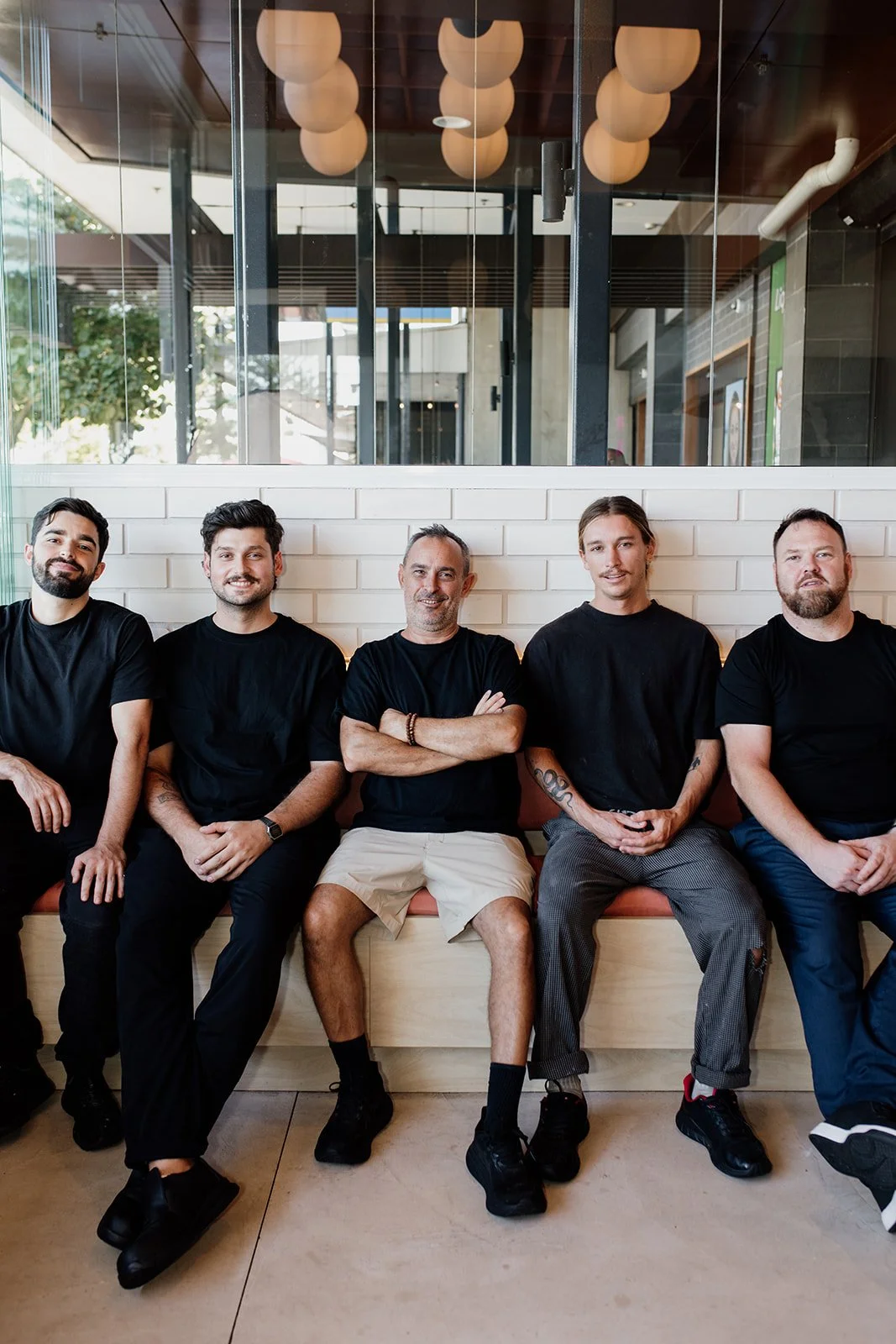 Gold Coast chefs sit together during Gold Coast chef photo shoot. 