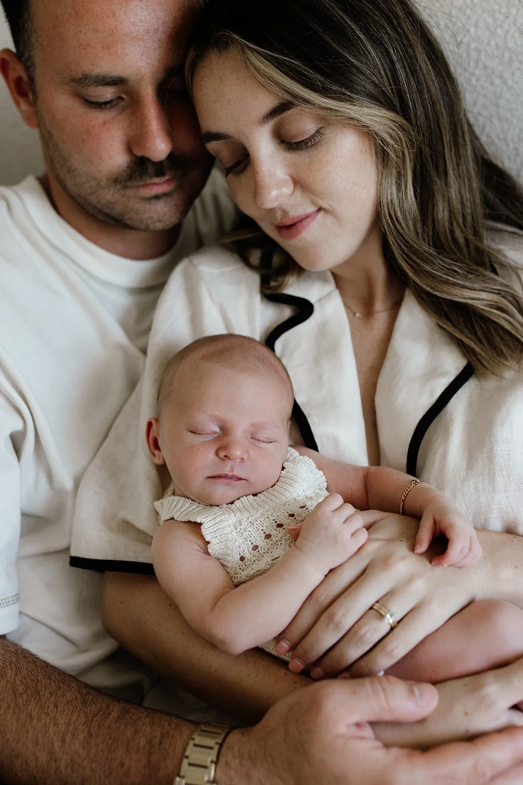Gold Coast photographer with young family at home during newborn photography session on the Gold Coast