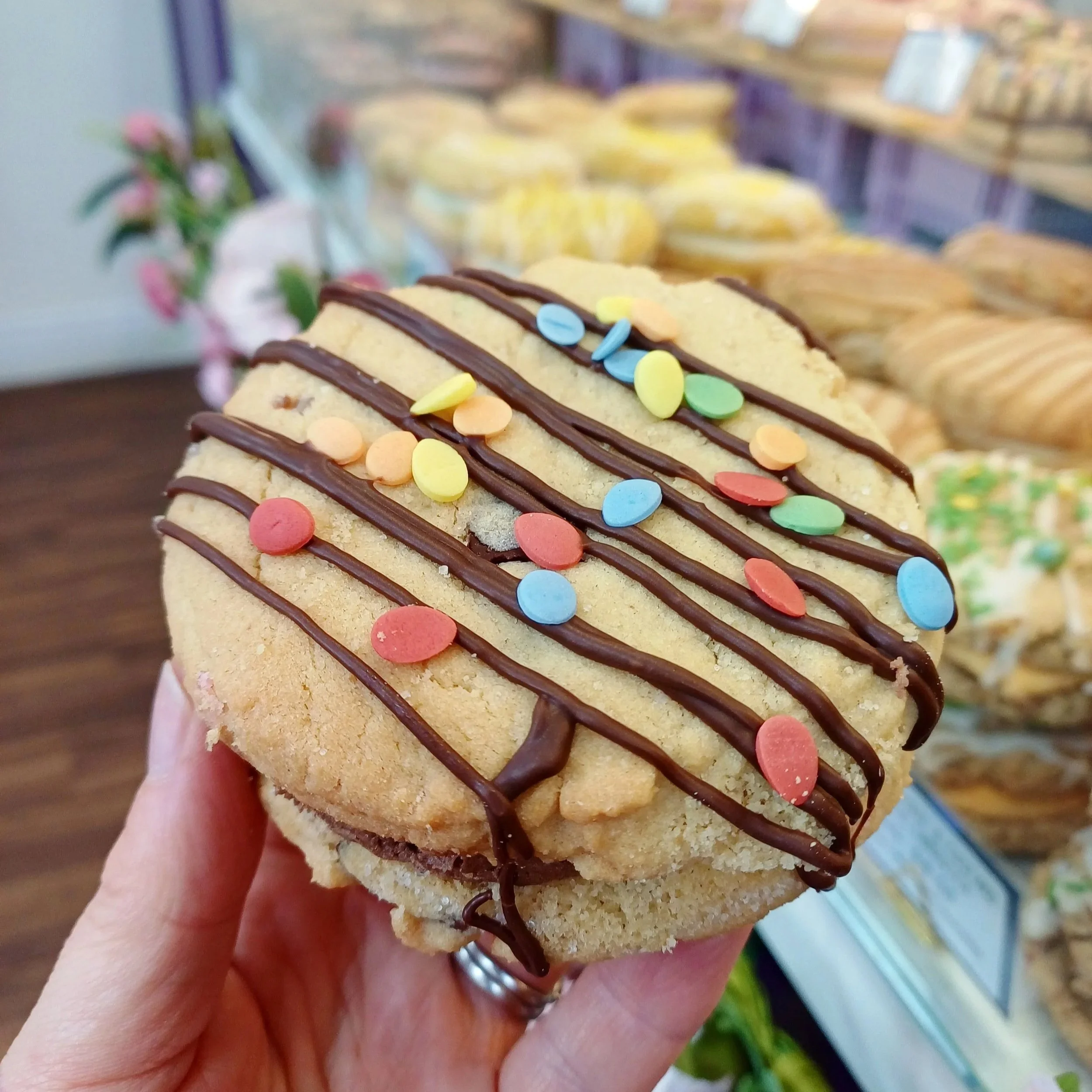 Hand holding mini egg cookie sandwich