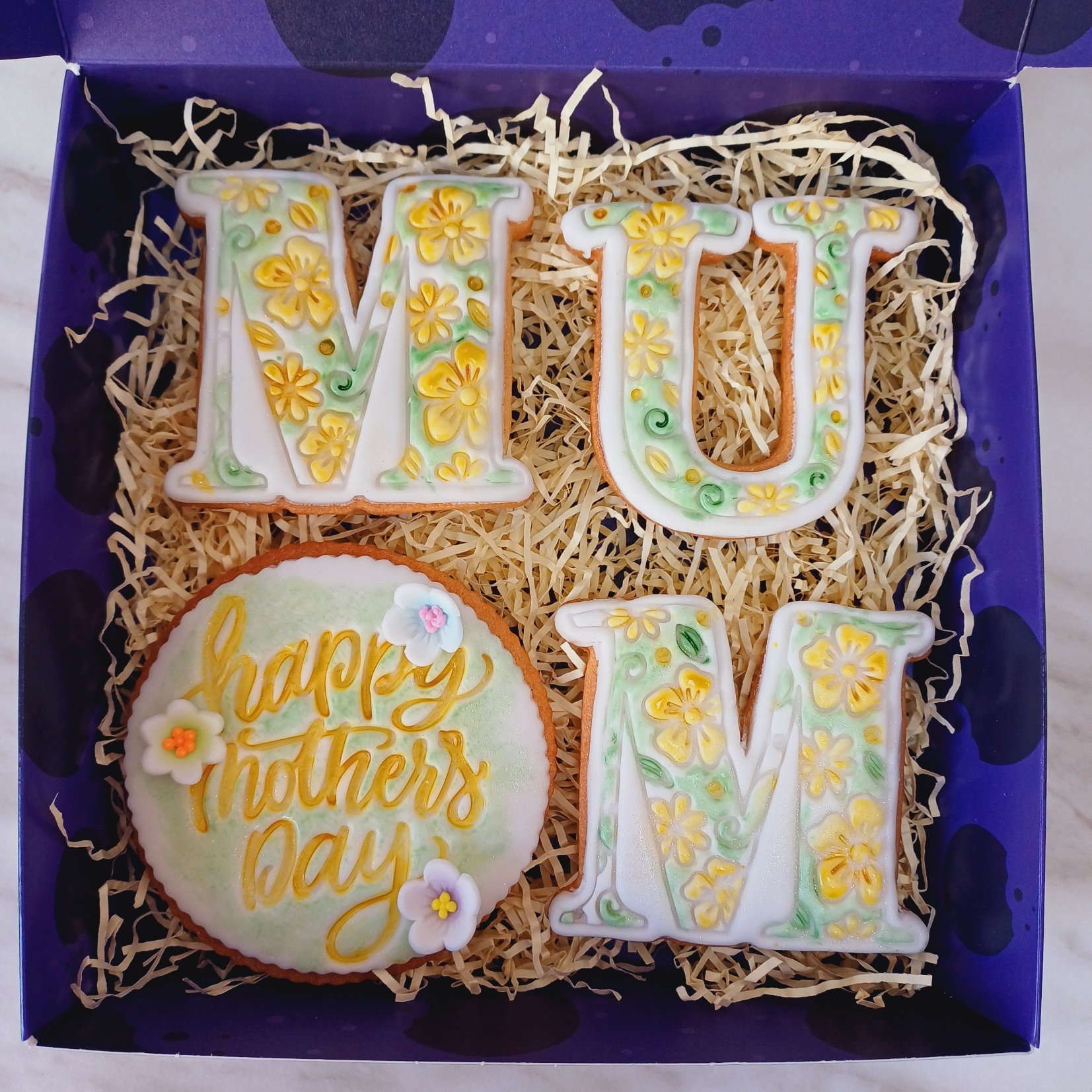 Box of beautifully crafted Mother's Day sugar cookies, perfect for gifting, with elegant packaging and vibrant decorations