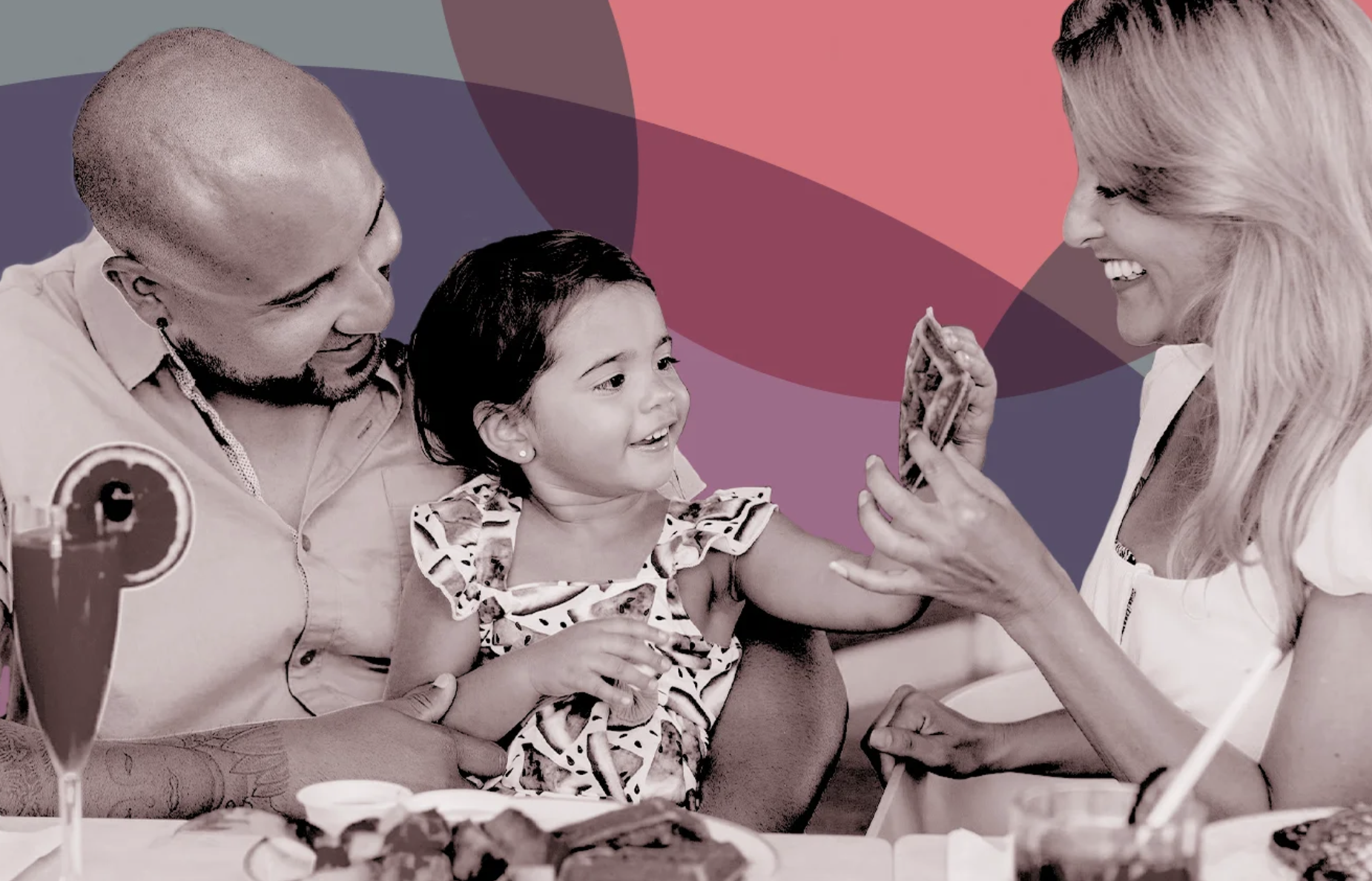 A photo of a small human child eating at a table with two adults against a pink and blue background