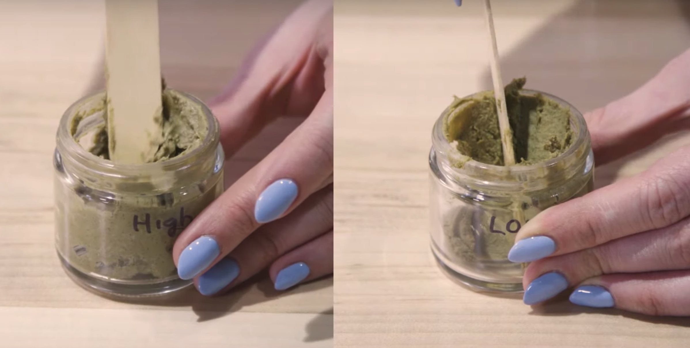 a photo of a human hand with lilac fingernails holding a small glass jar of something yellow-brown colored with a paste-like consistency 