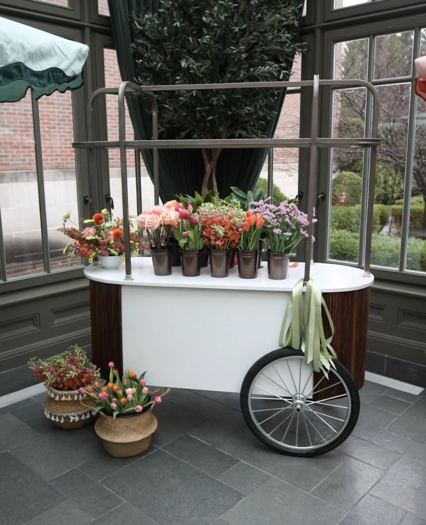Mobile flower cart by Klara’s Bloom Haus, a Metro Detroit floral studio, styled with fresh spring flowers including tulips, roses, and seasonal blooms for weddings, events, and pop-up luxury floral experiences.