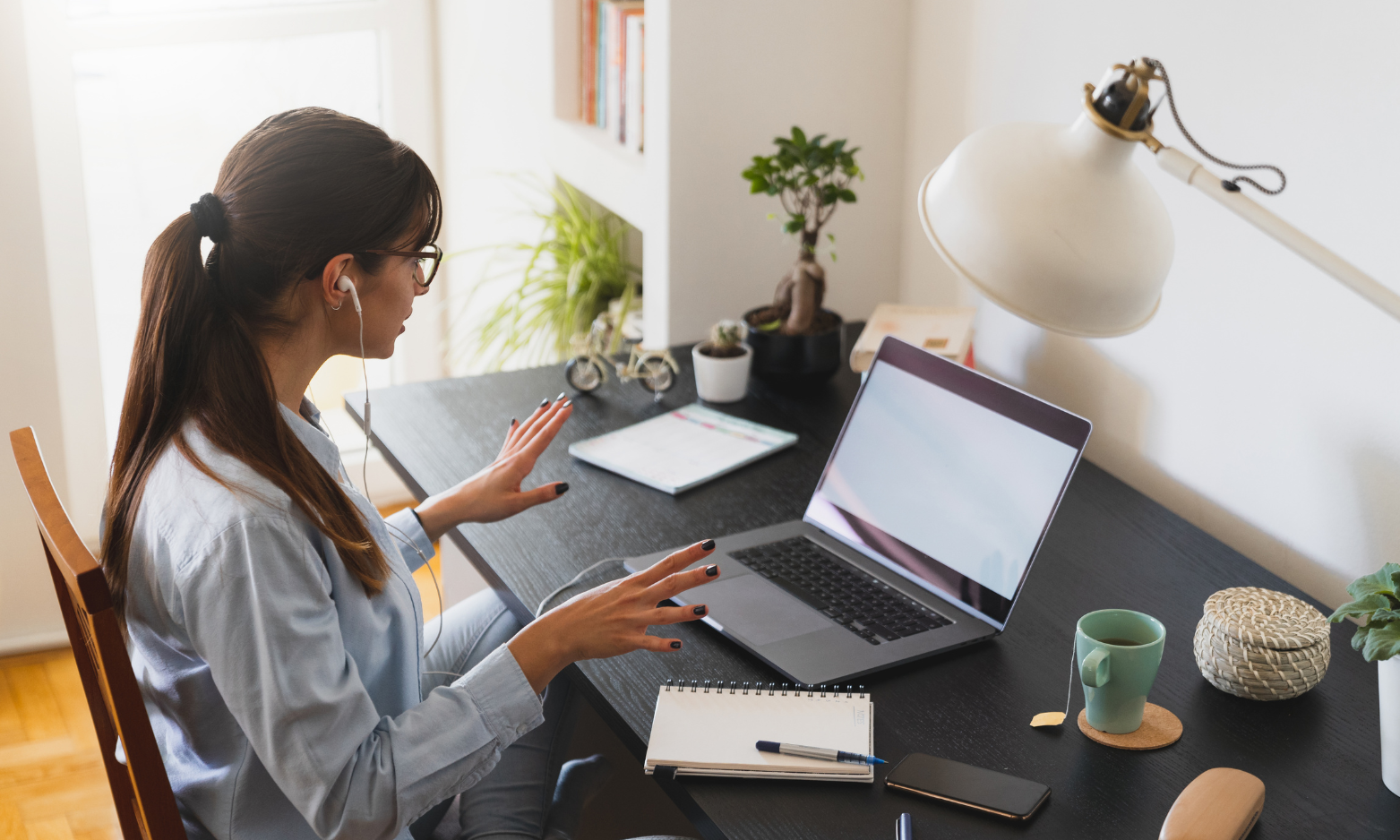 virtual assistant at desk with laptop and headphones