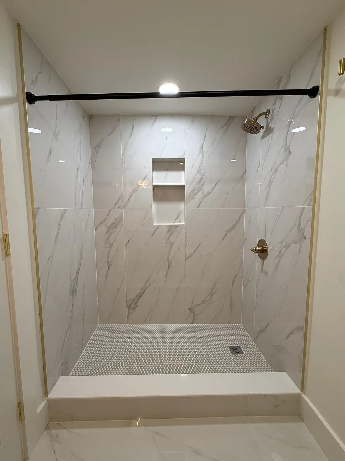 queens-court-09-bath-marble-shower-niche-brass.jpg