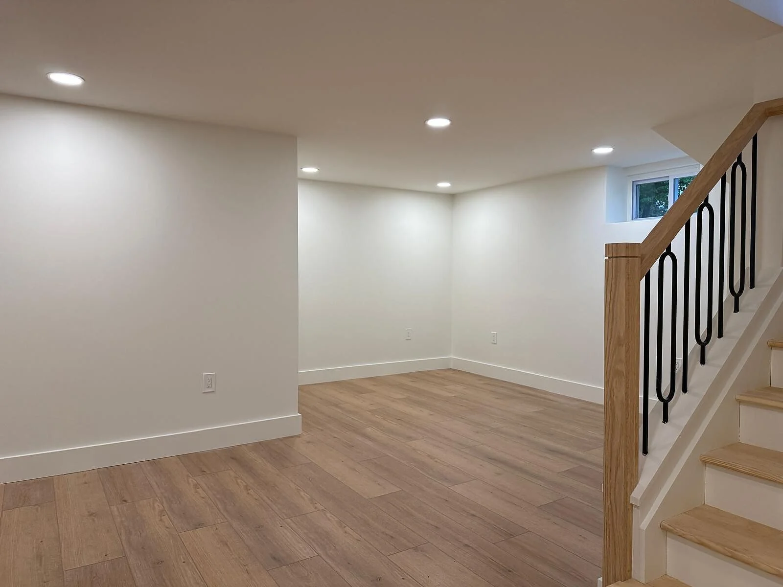 queens-court-08-finished-basement-stair-iron-railing.jpg