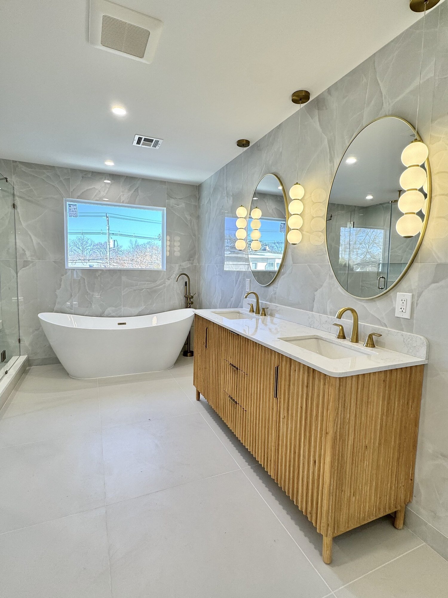 Woodland Road primary bathroom with freestanding tub and fluted oak double vanity