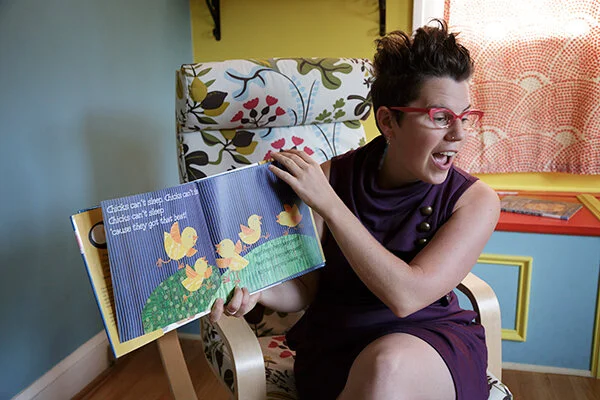 Storytime Amy displays a picture book for her audience.