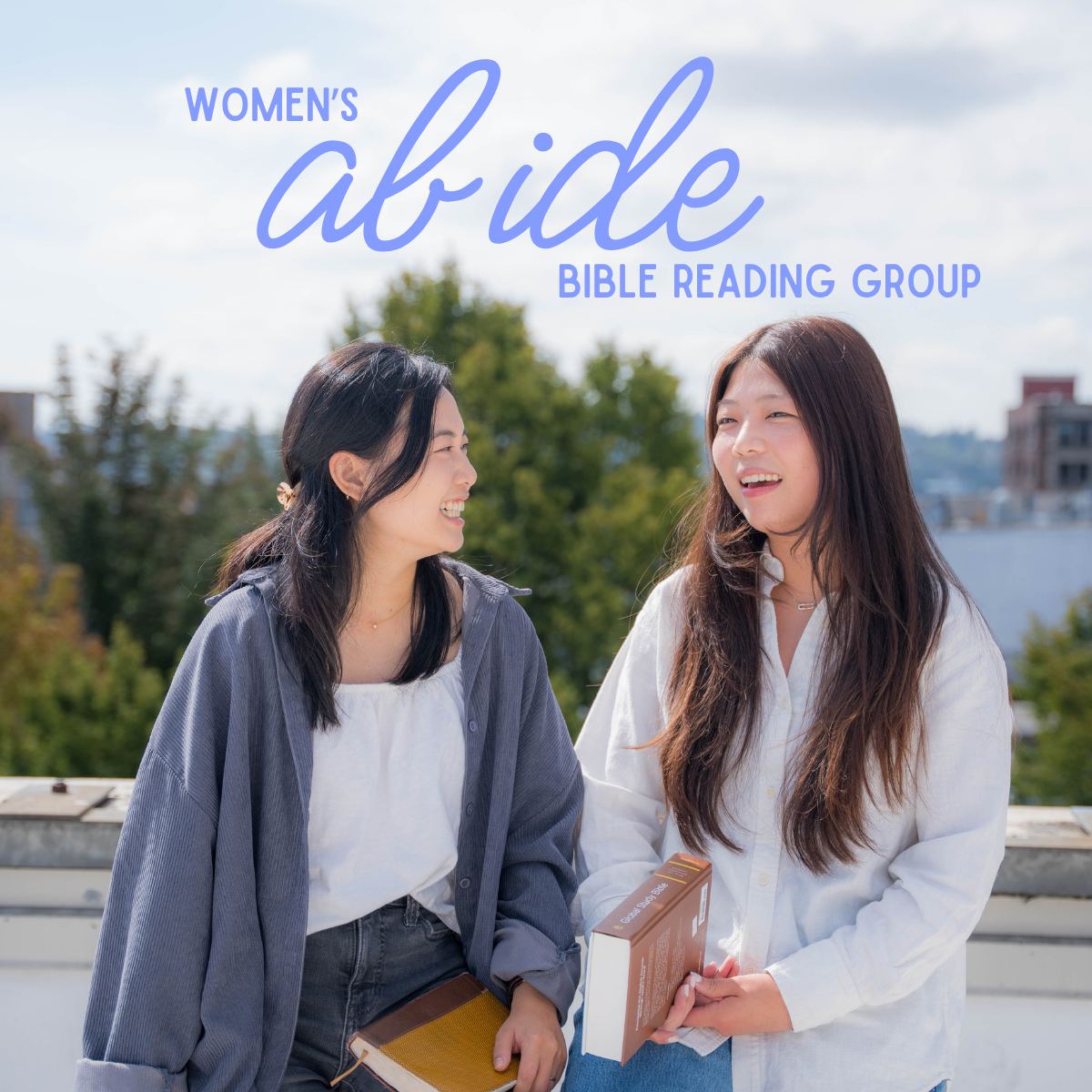 Two women outdoors on a sunny day, smiling and talking, holding books, with trees and buildings in the background, promoting a women's Bible reading group.