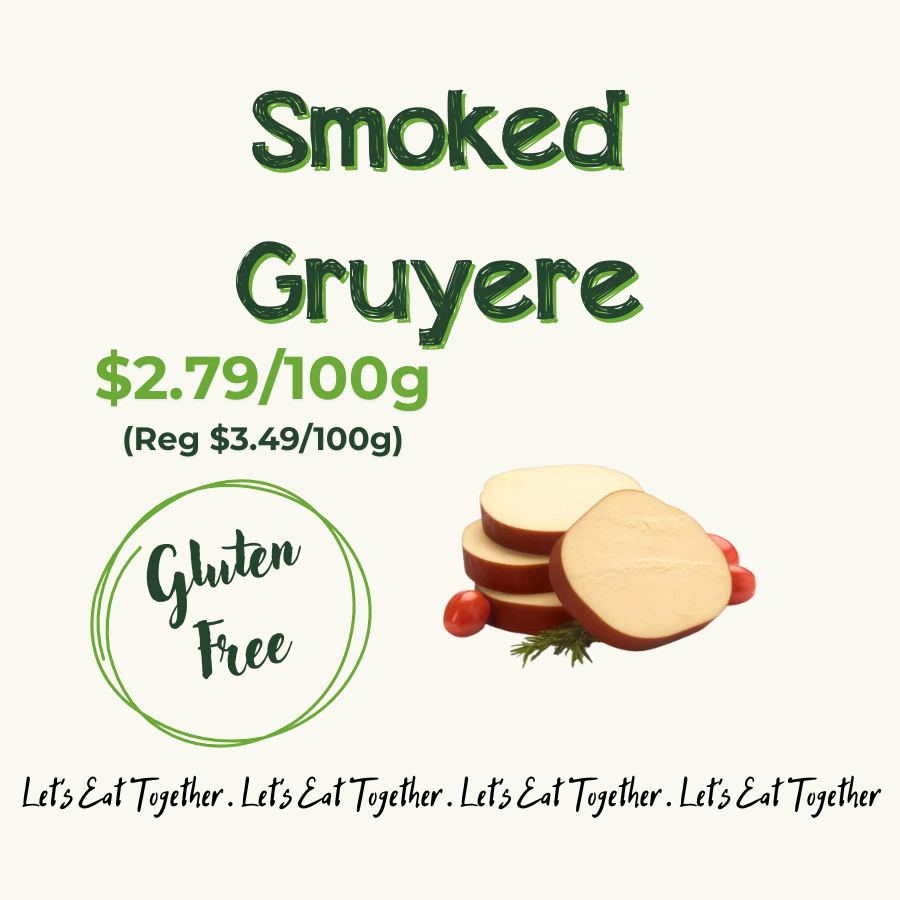 Sign advertising smoked Gruyere cheese priced at $2.79 per 100 grams, gluten free, with a picture of sliced cheese and cherry tomatoes.