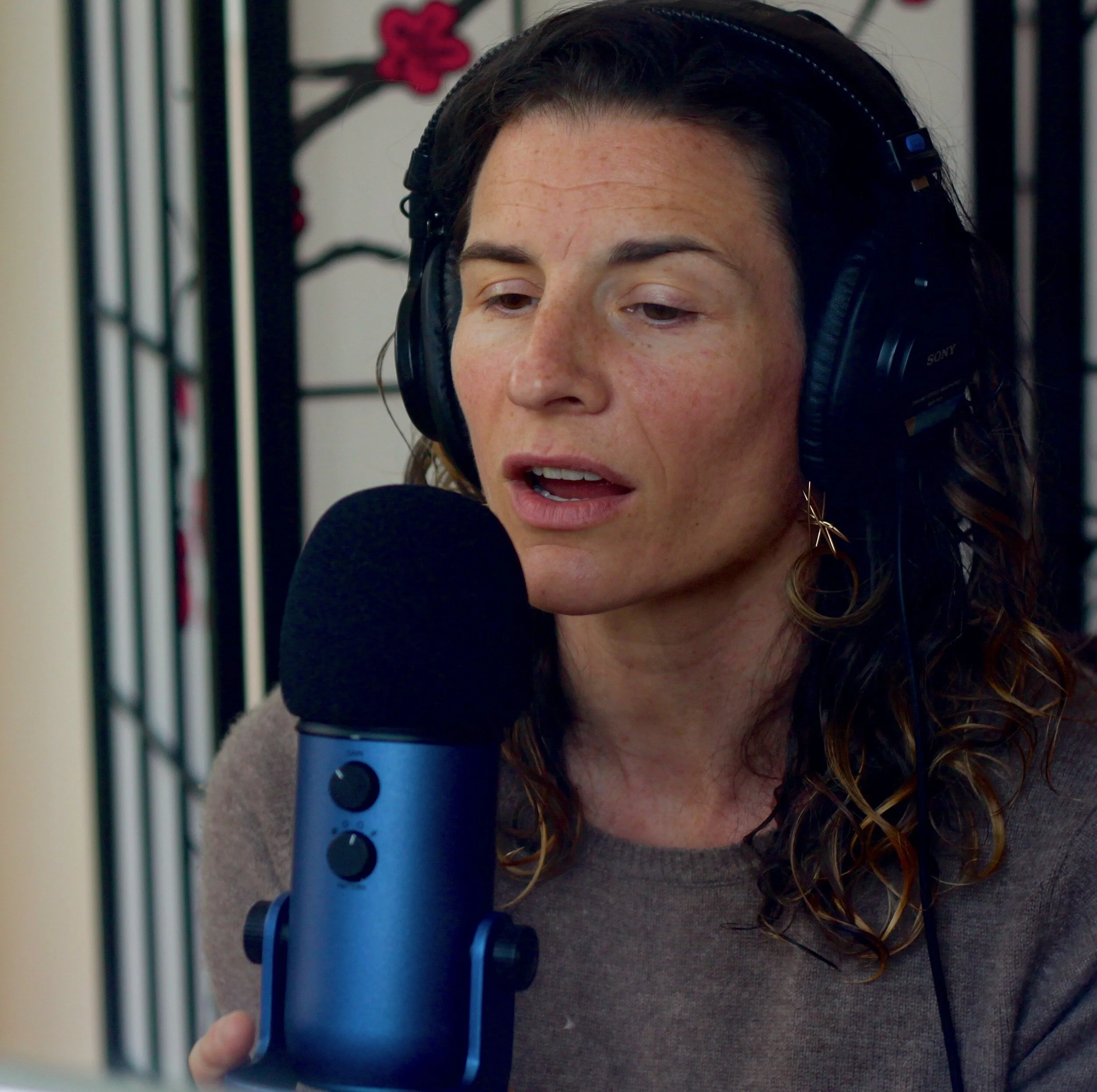 Laura with microphone square.jpeg