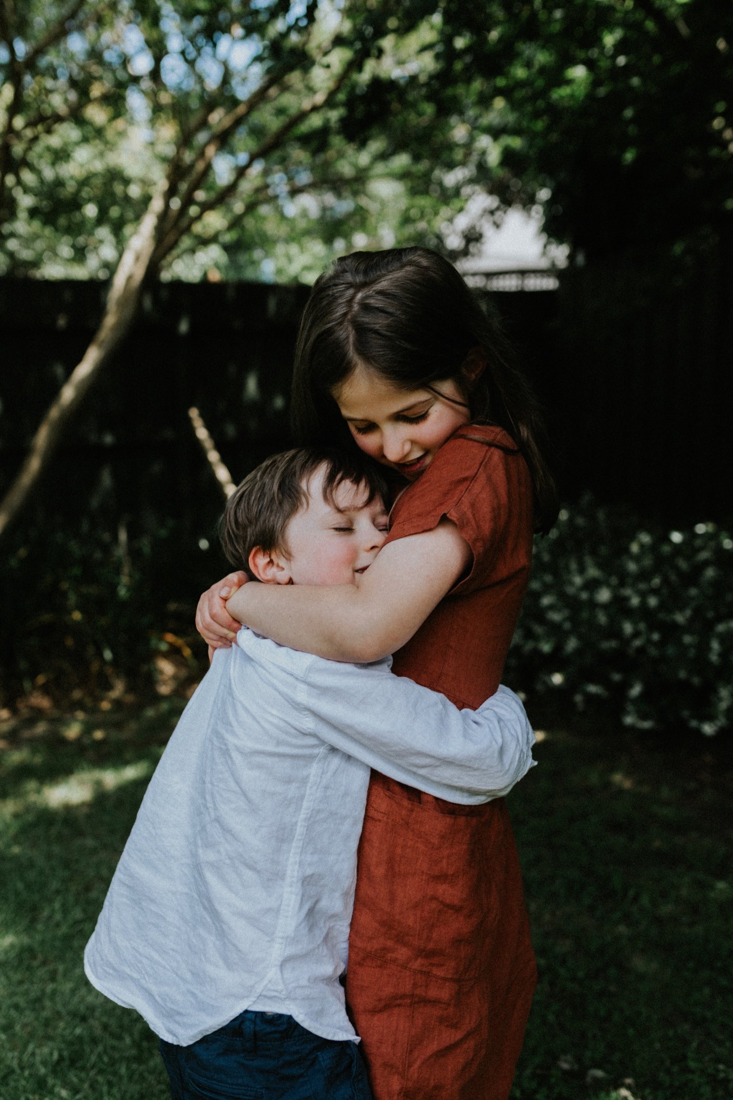 TheHechtmans-38_Colour portrait of siblings hugging in their back yard, both closing their eyes .jpg