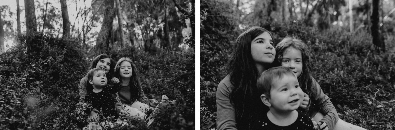 06_SwerdlinFamily2022-25_SwerdlinFamily2022-20_Black and white photo of the sisters as they sit cuddled up in the tall greenery _Black and white close up photo of the sisters as they sit cuddled up in the tall greenery .jpg