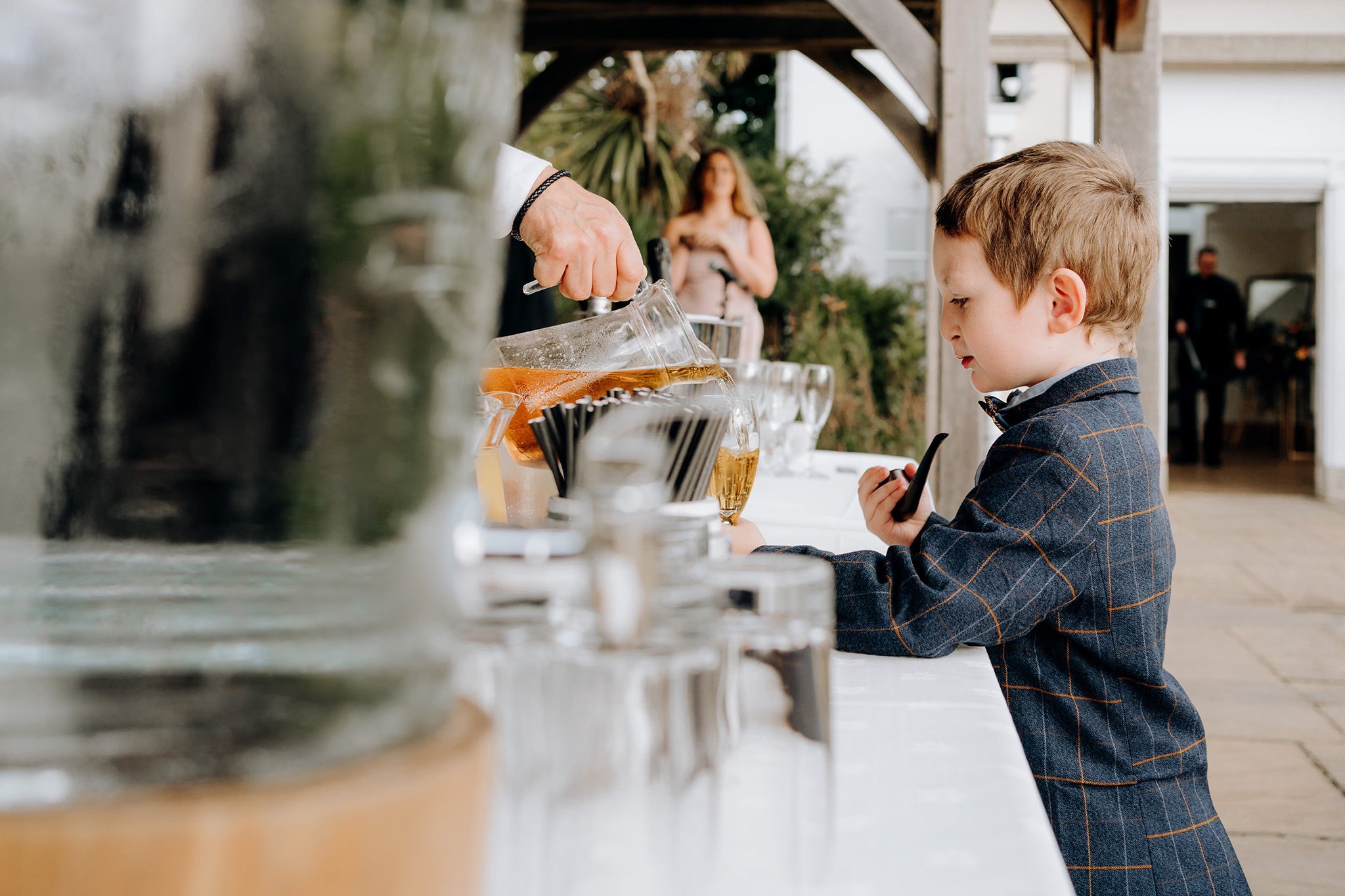 Young wedding guest with a pipe getting refreshments