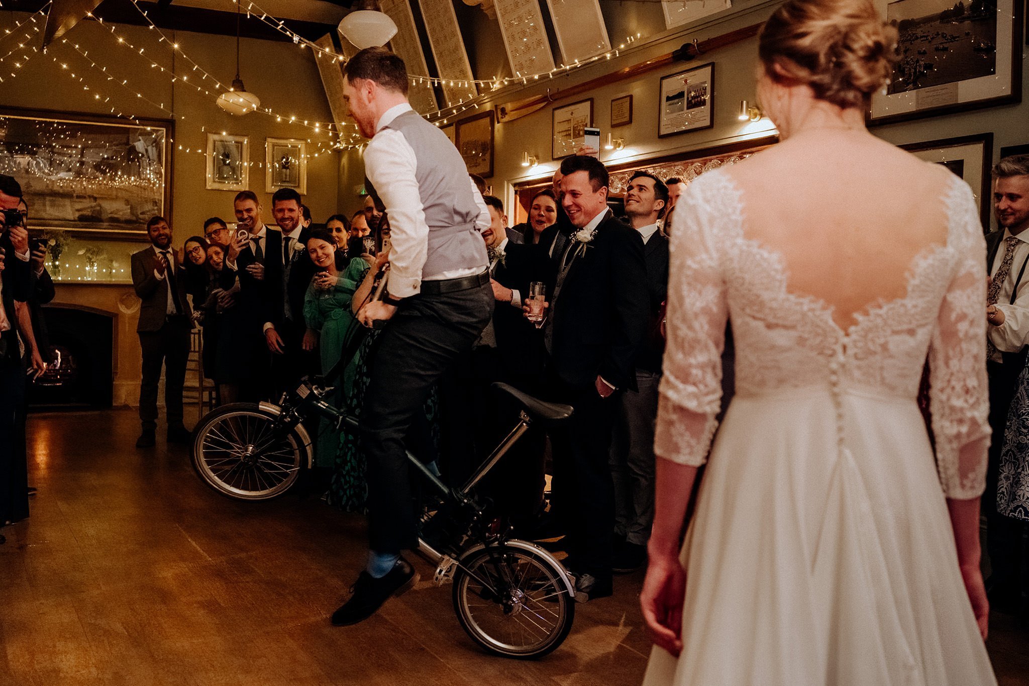 groom arriving for the first dance on a bike