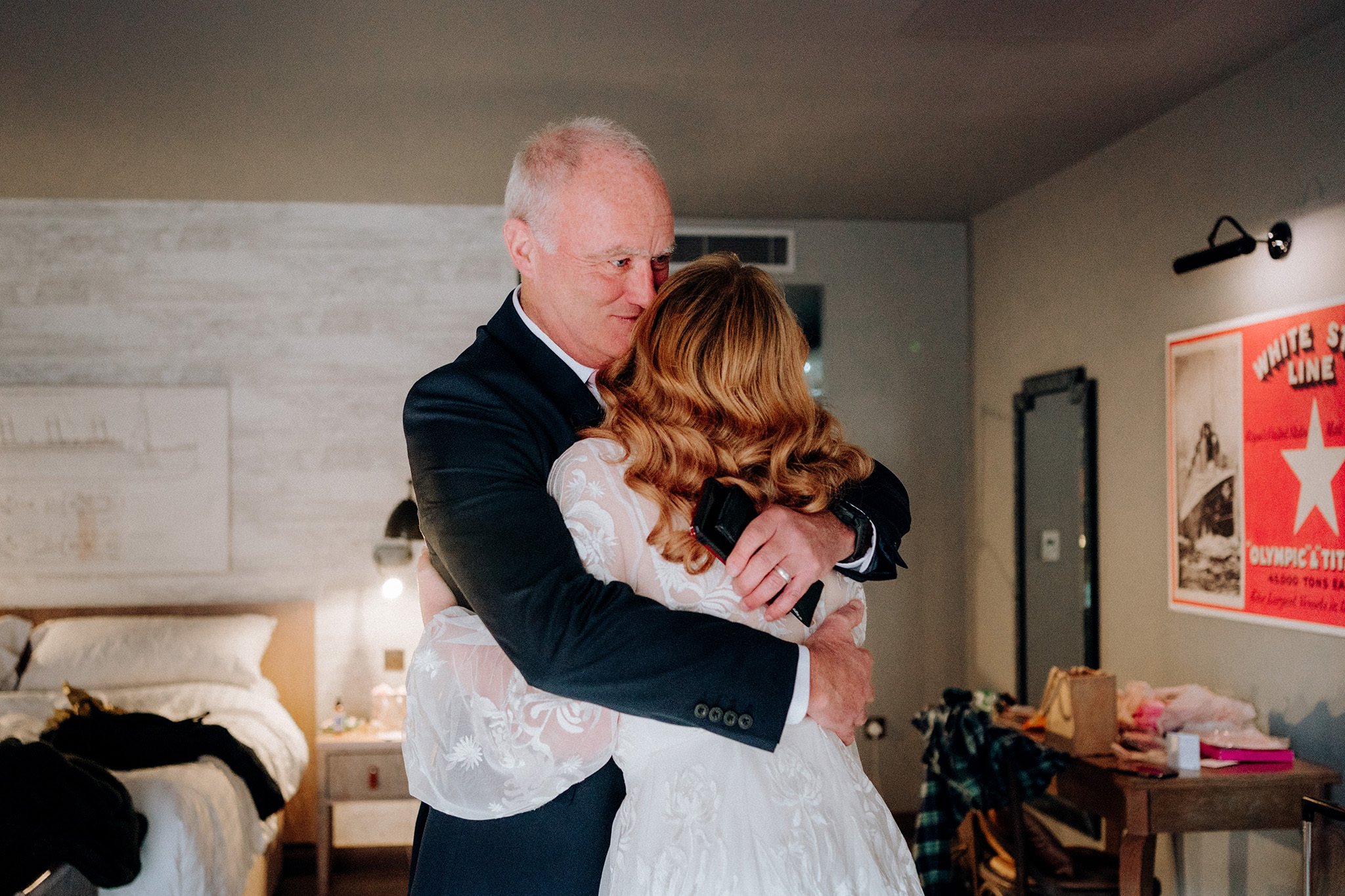 Father and daughter share a hug on the morning of her wedding